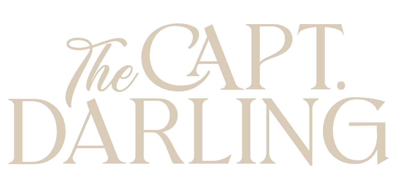 Text graphic that says "The Capt. Daring" in beige font on a black background.