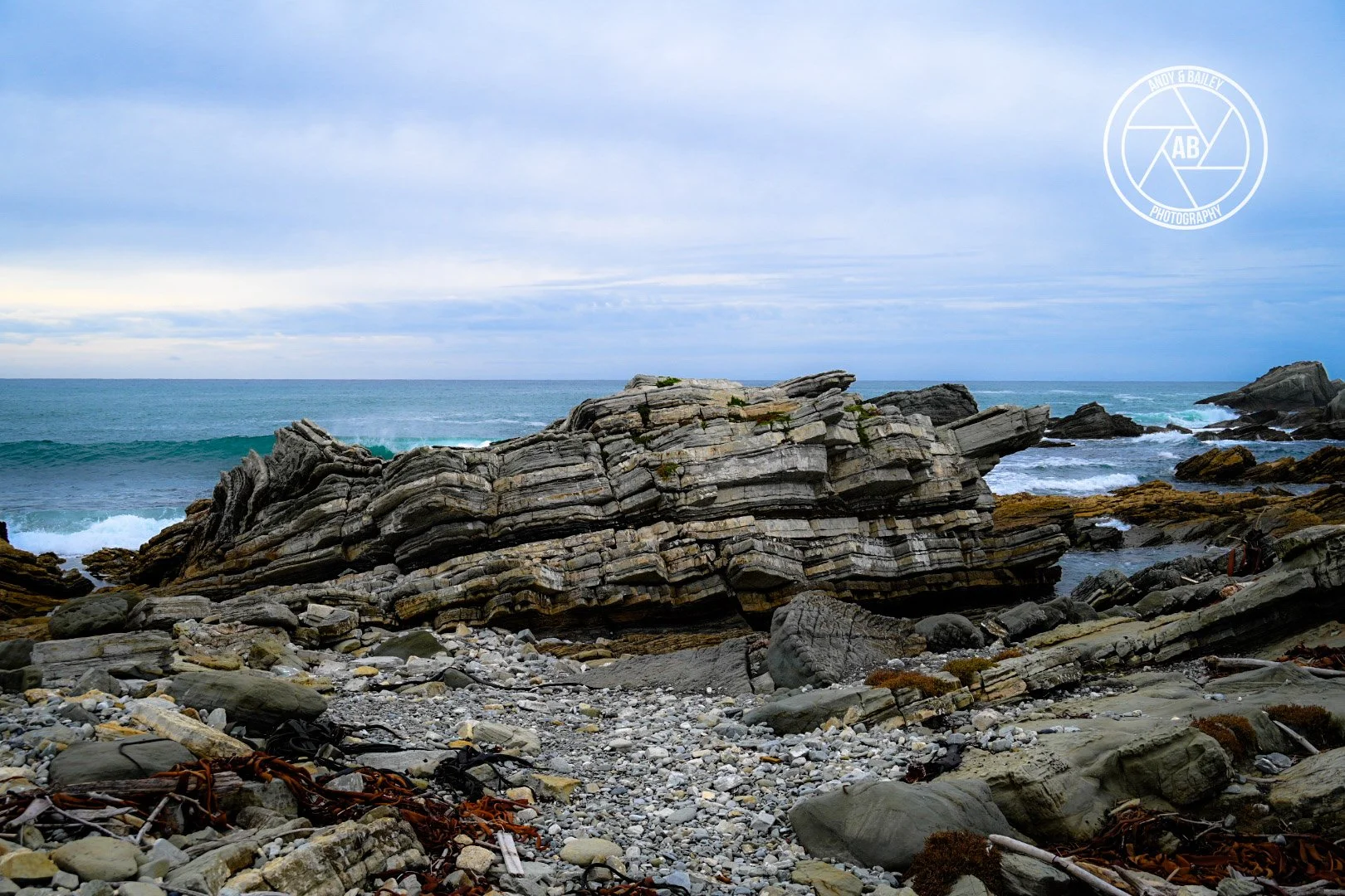 Coastal landscape with rocky shoreline, seen during the optional extra extension on The Last Resort trail, Tora, Wairarapa.
