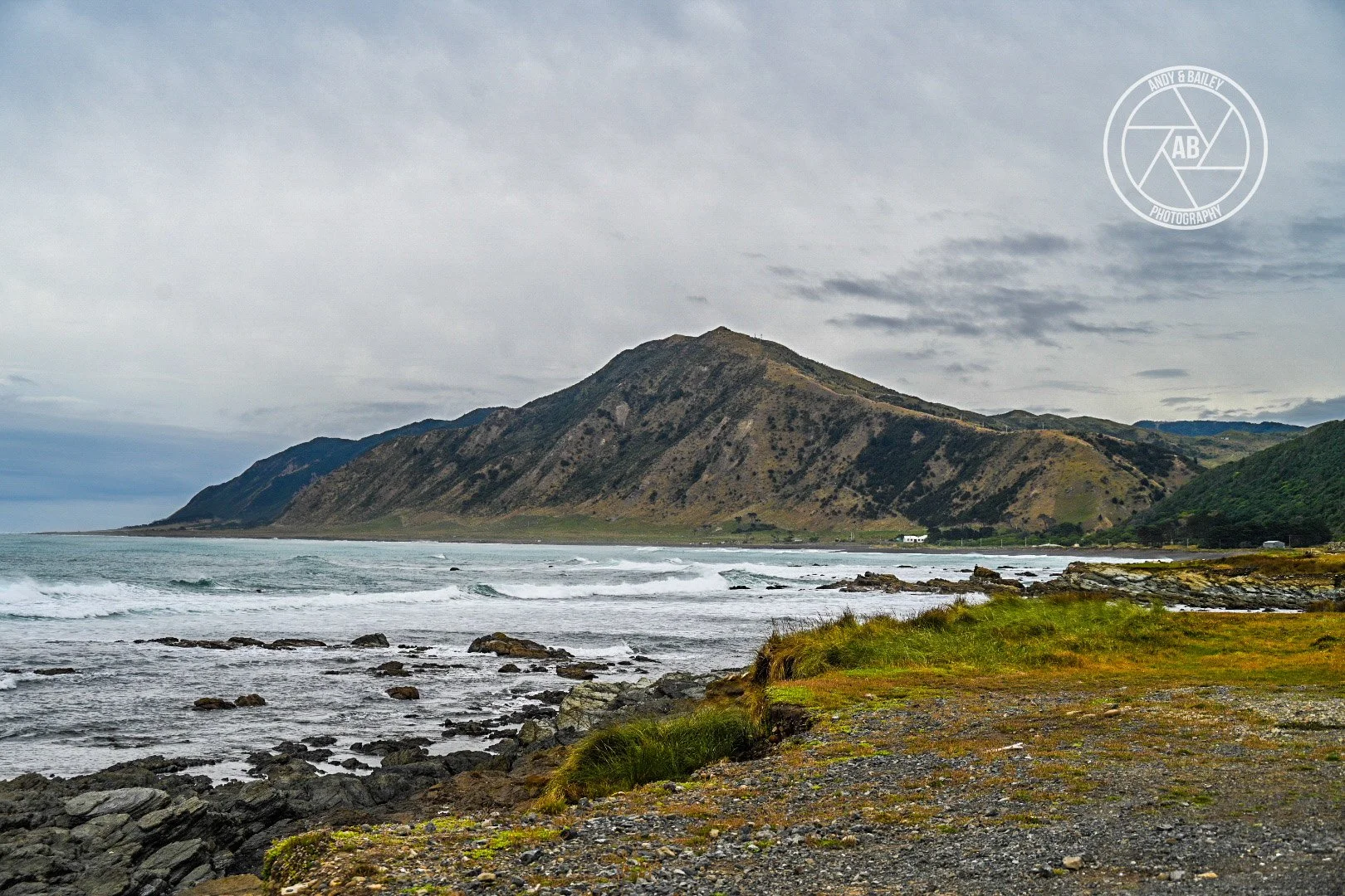 Coastal landscape with rocky shoreline, seen during the optional extra extension on The Last Resort trail, Tora, Wairarapa.