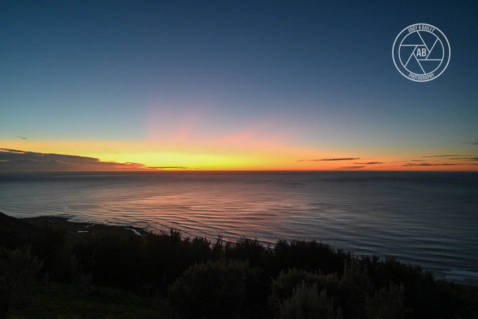 Scenic view of a sunset over the ocean with a colourful sky at The Last Resort trail, Tora, Wairarapa.