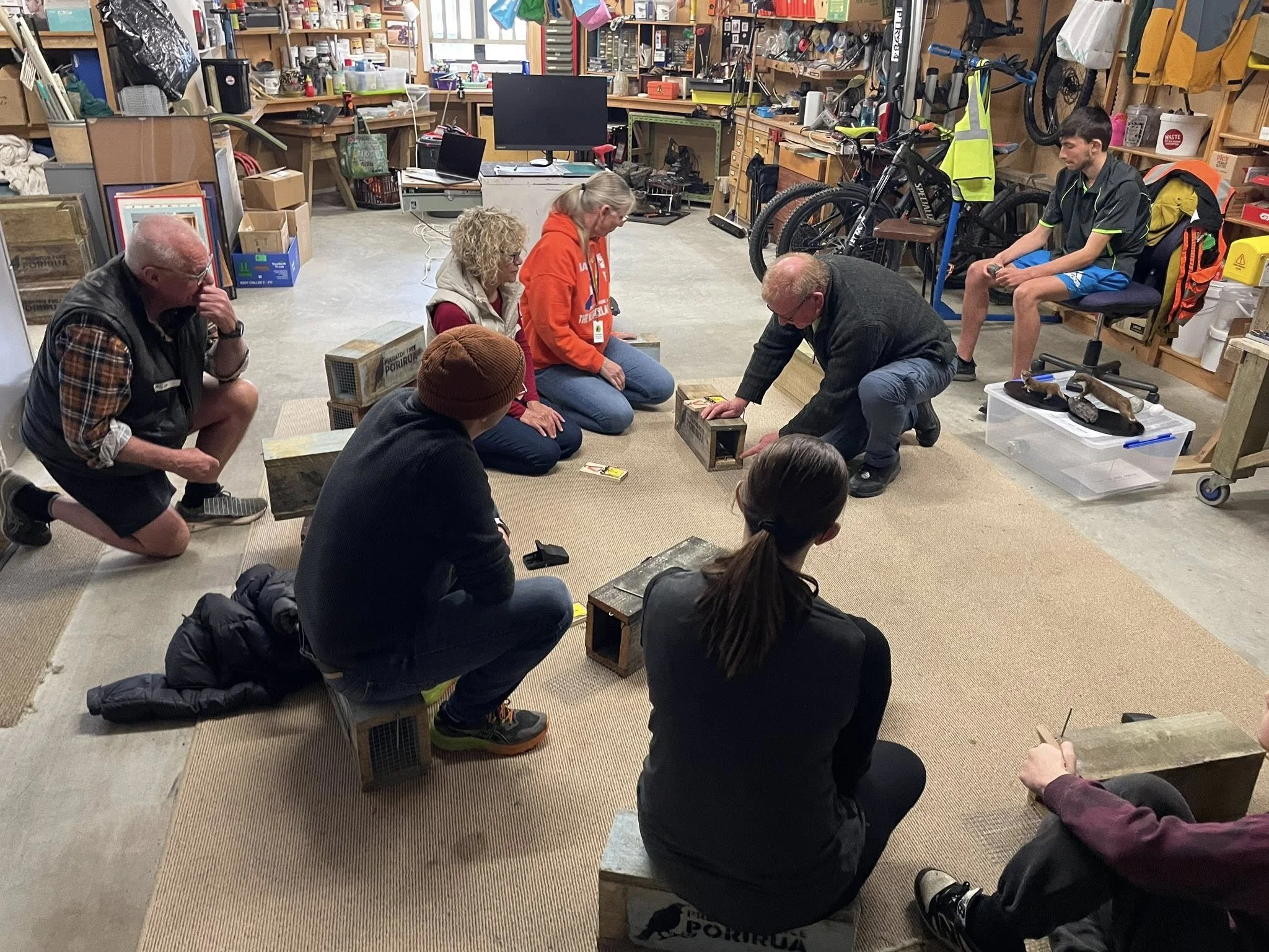 Photo of people being shown how to use a trap safely