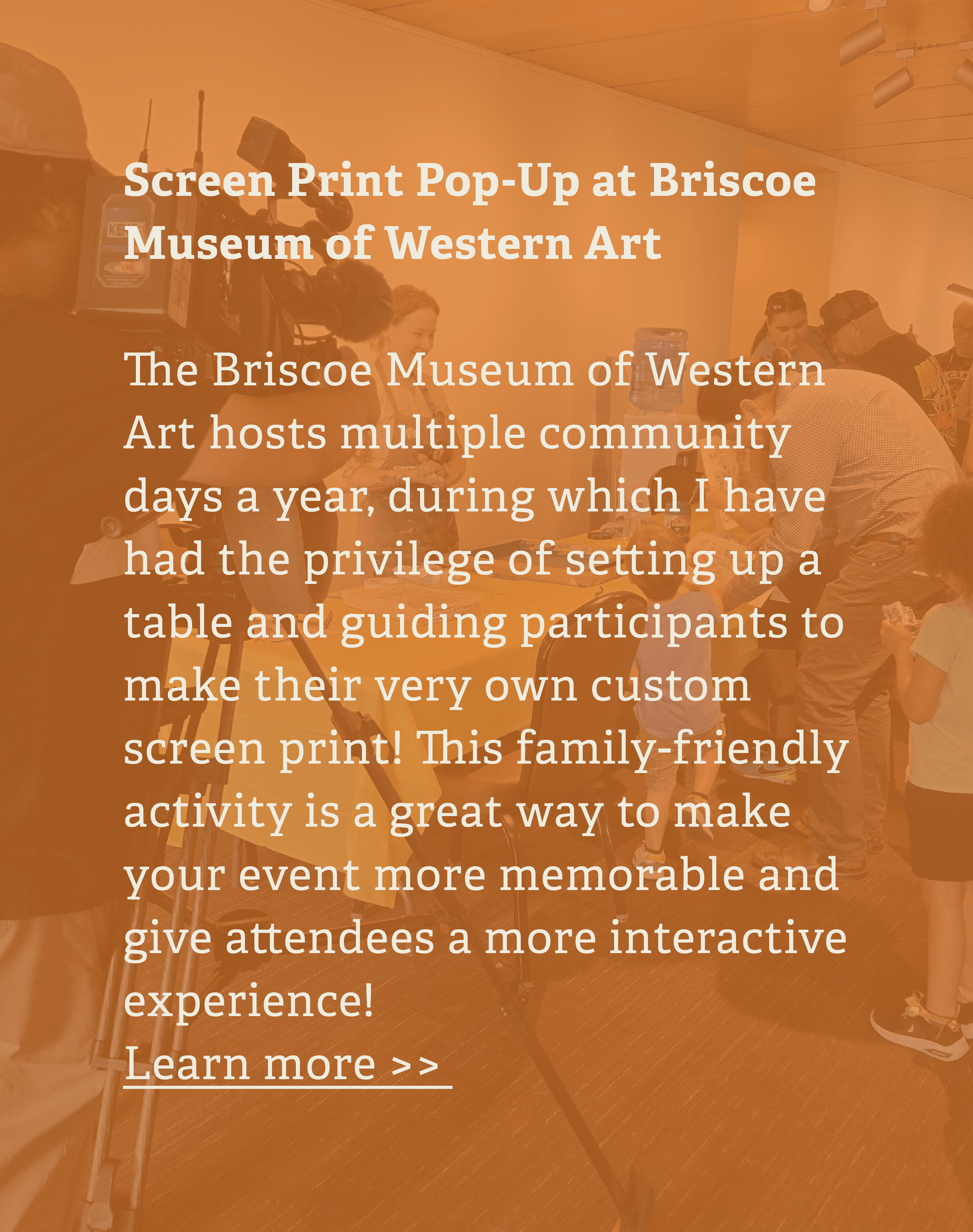 People participating in a screen print activity at the Briscoe Museum of Western Art, with one person using a camera and several people gathered around tables.