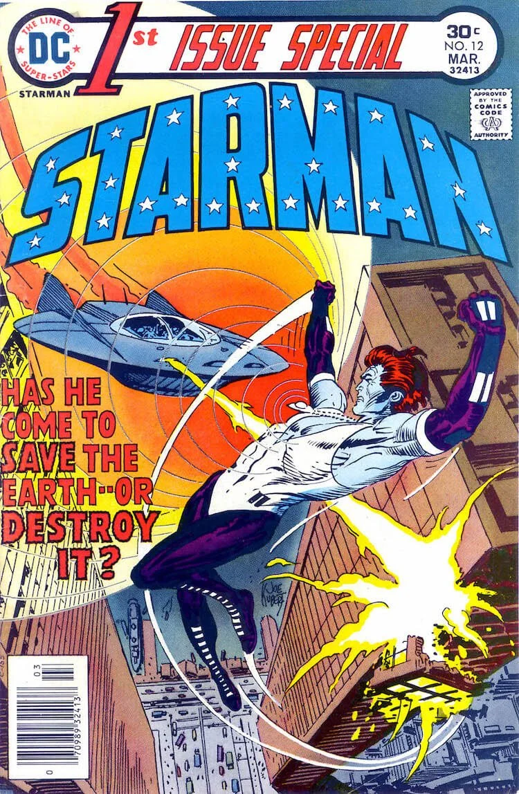 The cover of 1st Issue Special #12, showing Mikaal, a blue-skinned alien with red hair wearing an amulet, flying and dodging a blast from a spaceship.