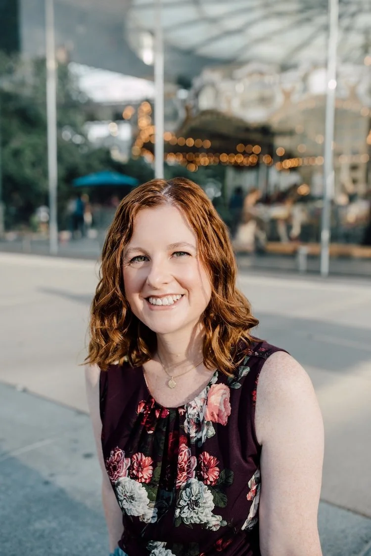Jessica Plummer smiling at the camera, with a carousel behind her.