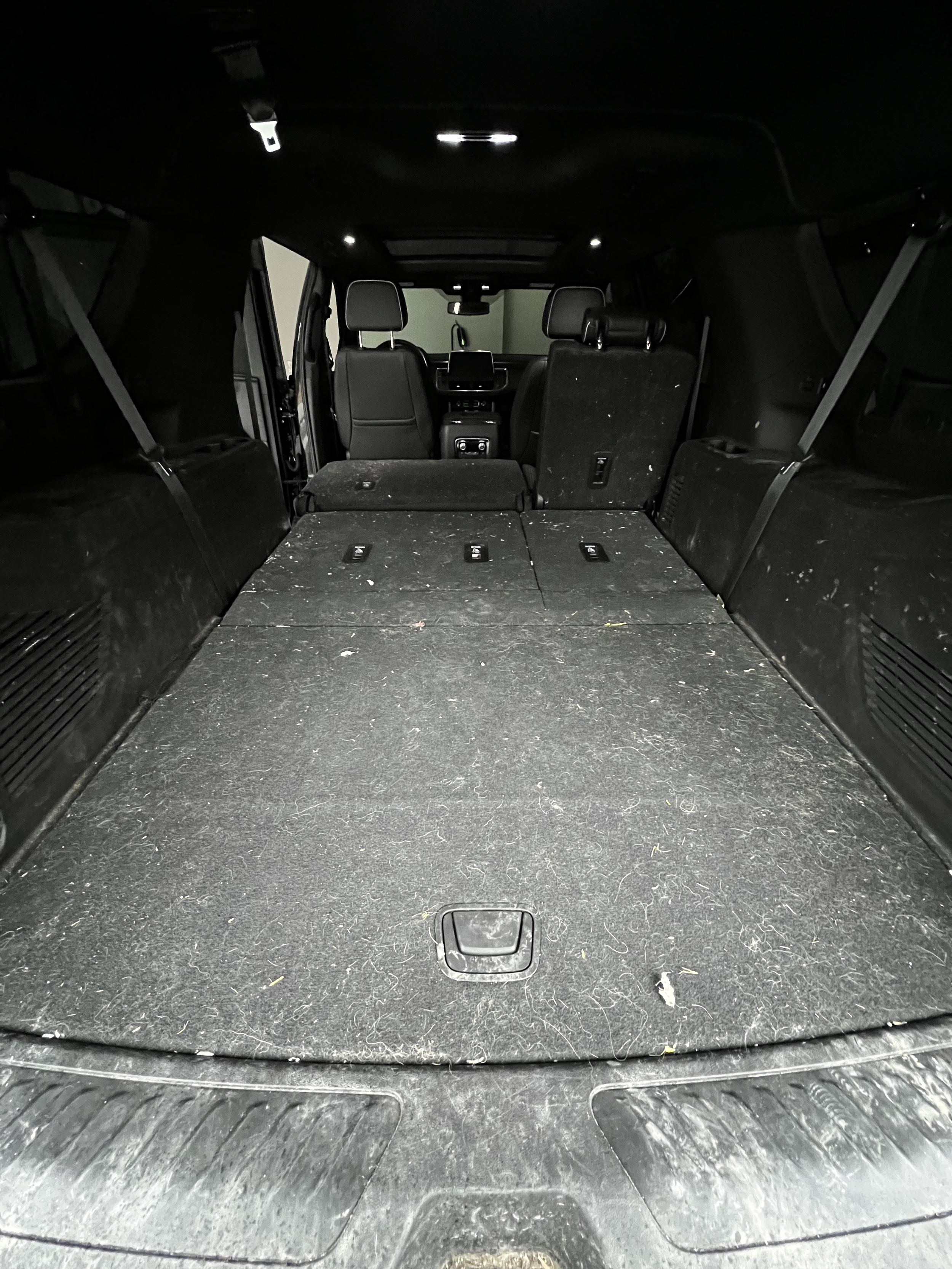 SUV interior with seats folded down, creating a large cargo space