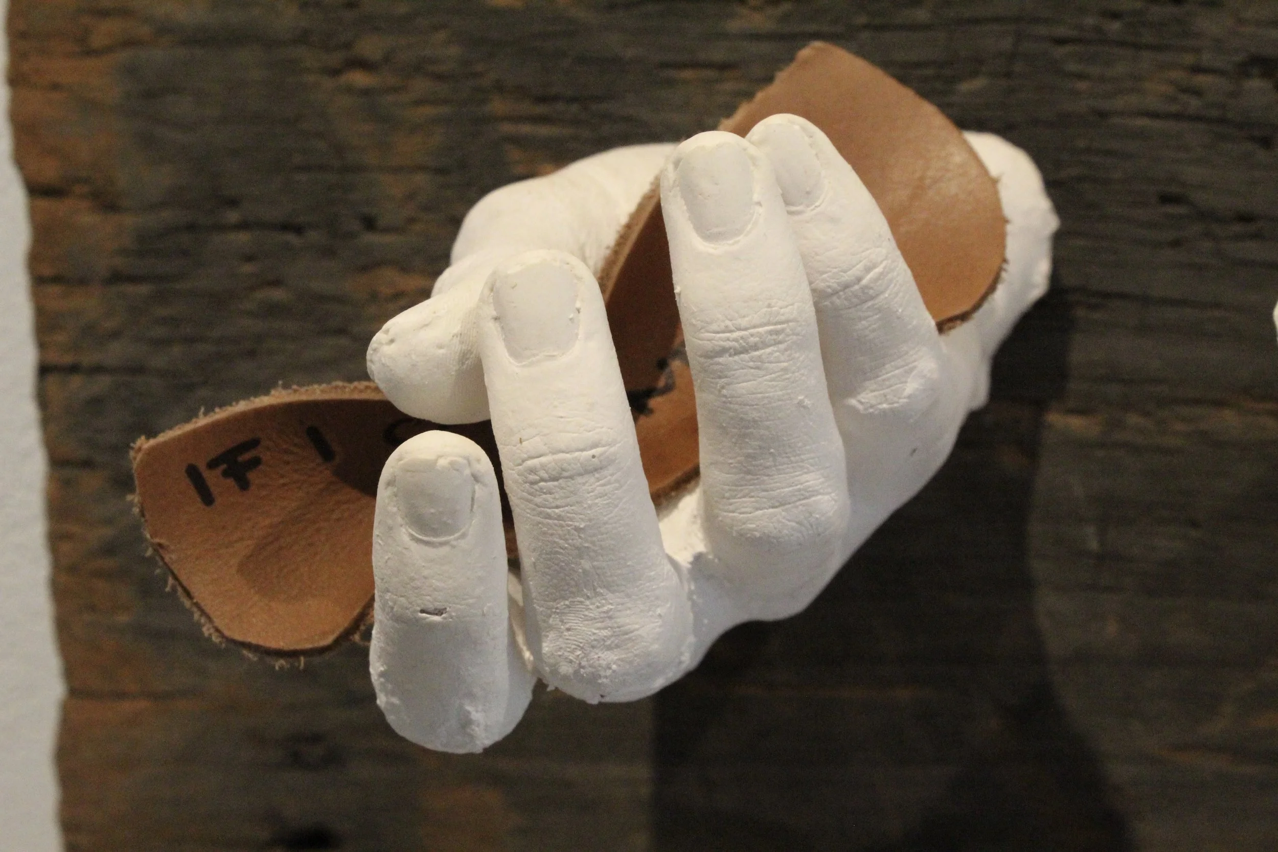 give it over, make me held (2026) (detail), wood, leather, plaster