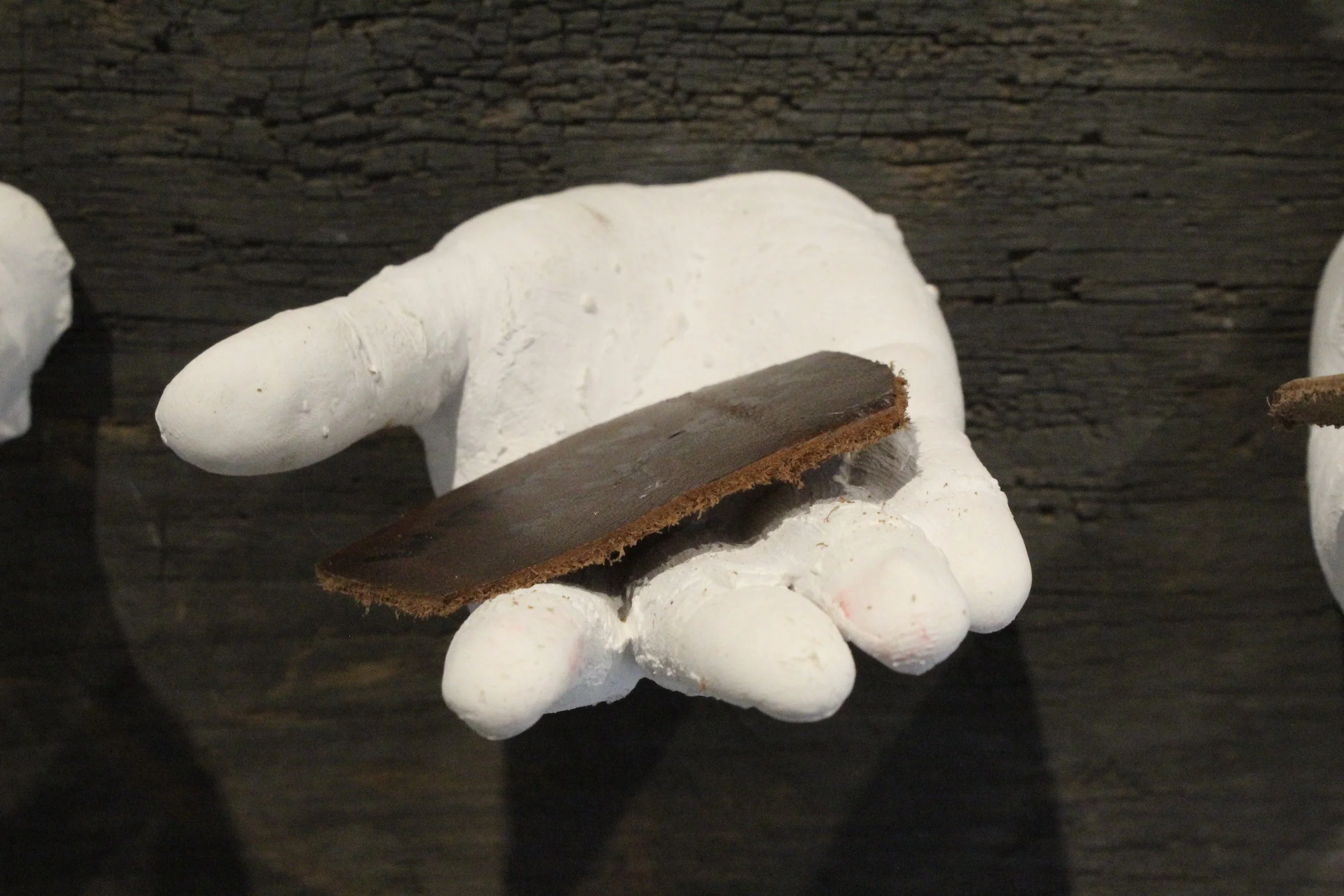 give it over, make me held (2026) (detail), wood, leather, plaster