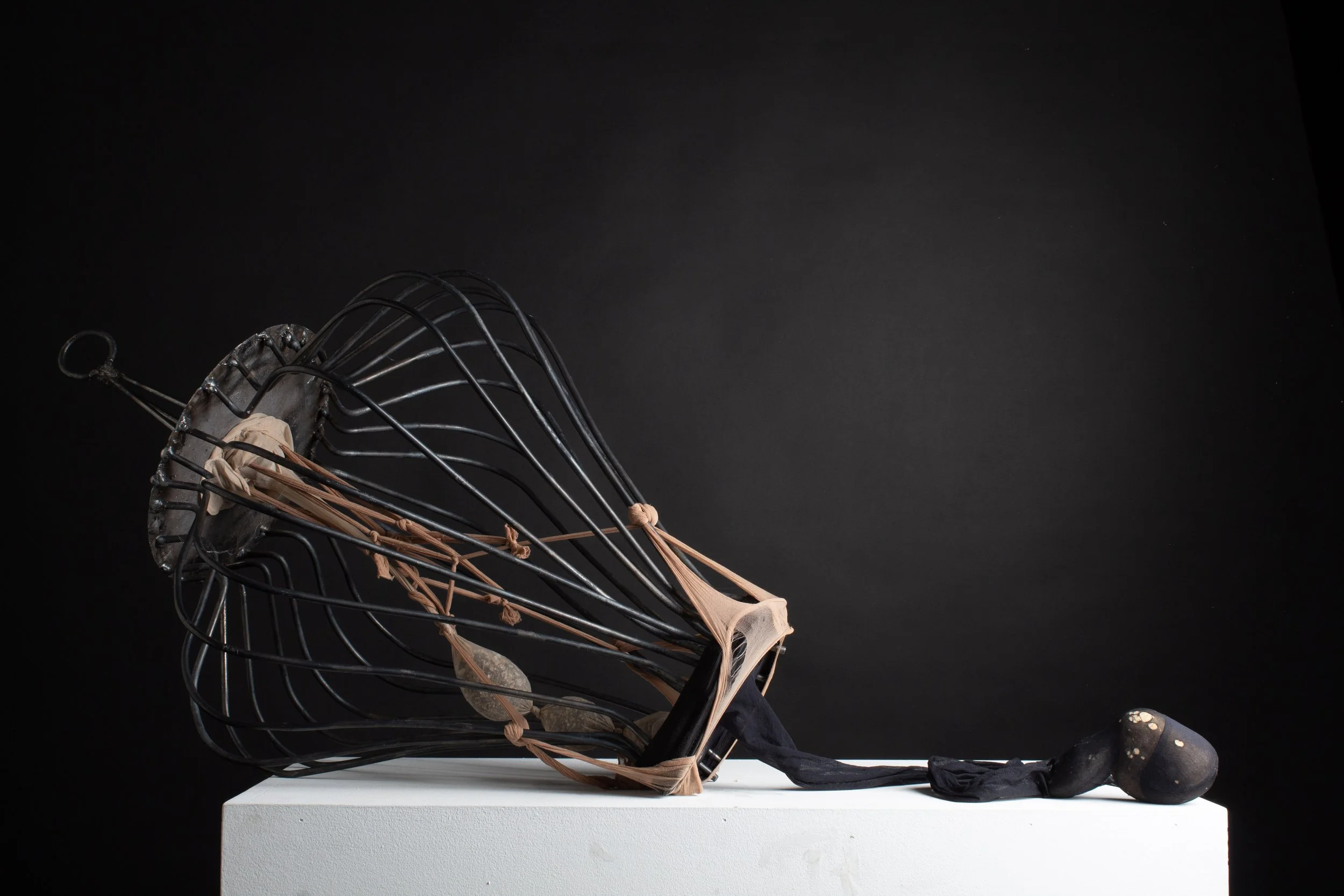 cycle (2024), steel, nylon stockings, stones