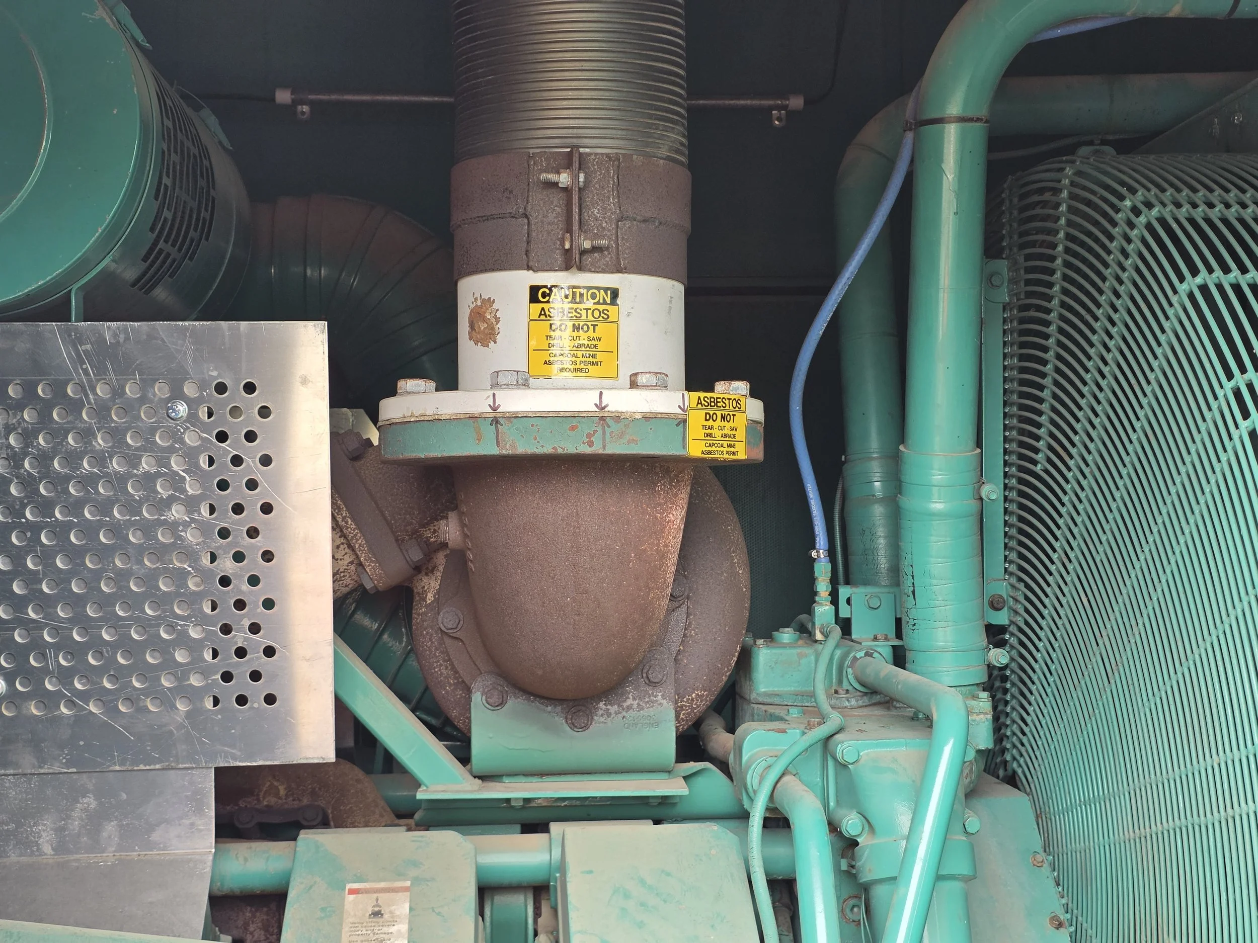 asbestos gasket in a generator exhaust with asbestos label