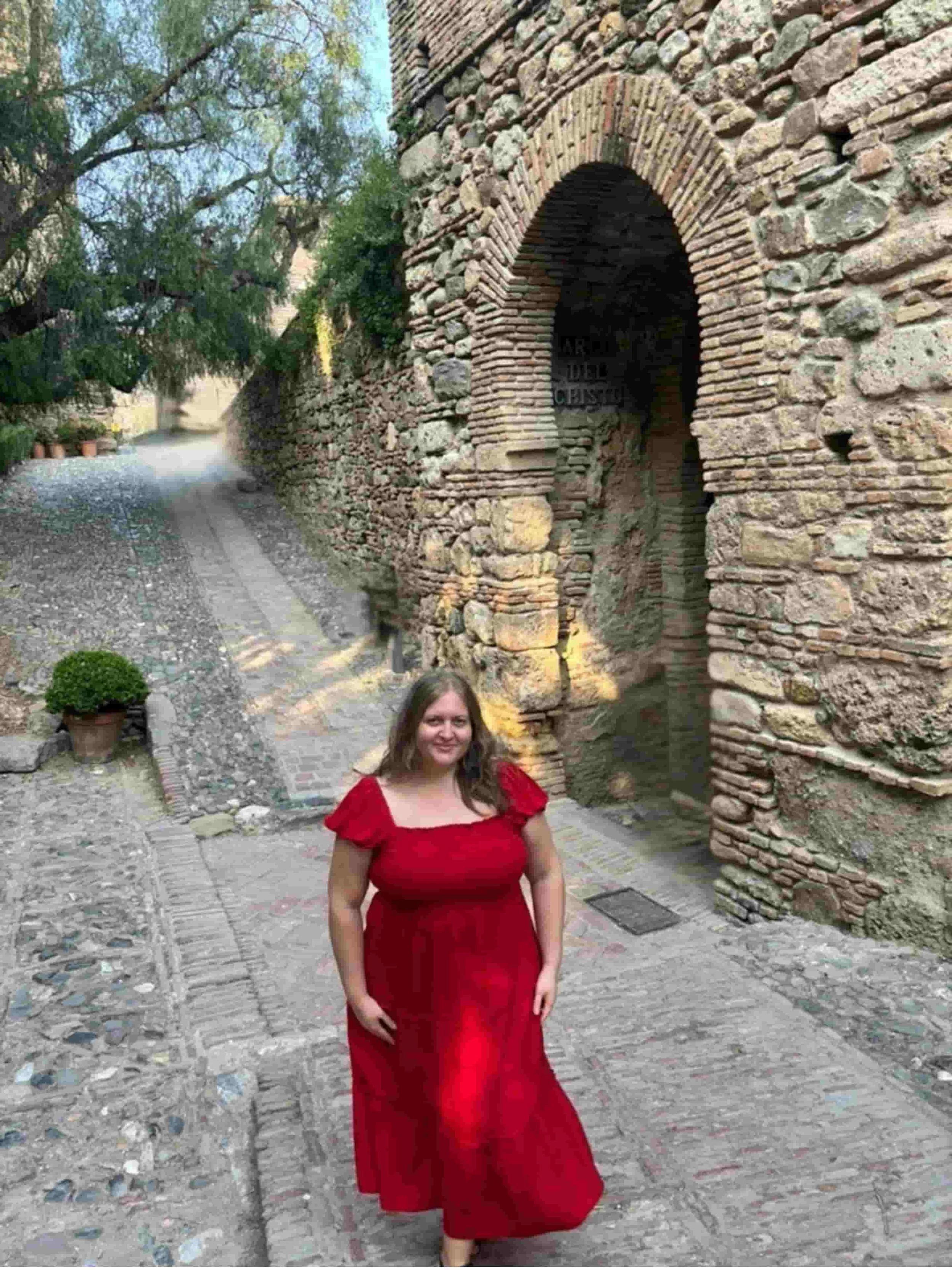 Karina Ramirez, Somatic Facilitator, Spanish Coach and Connection Coach, in Malaga, Spain, wearing a red dress