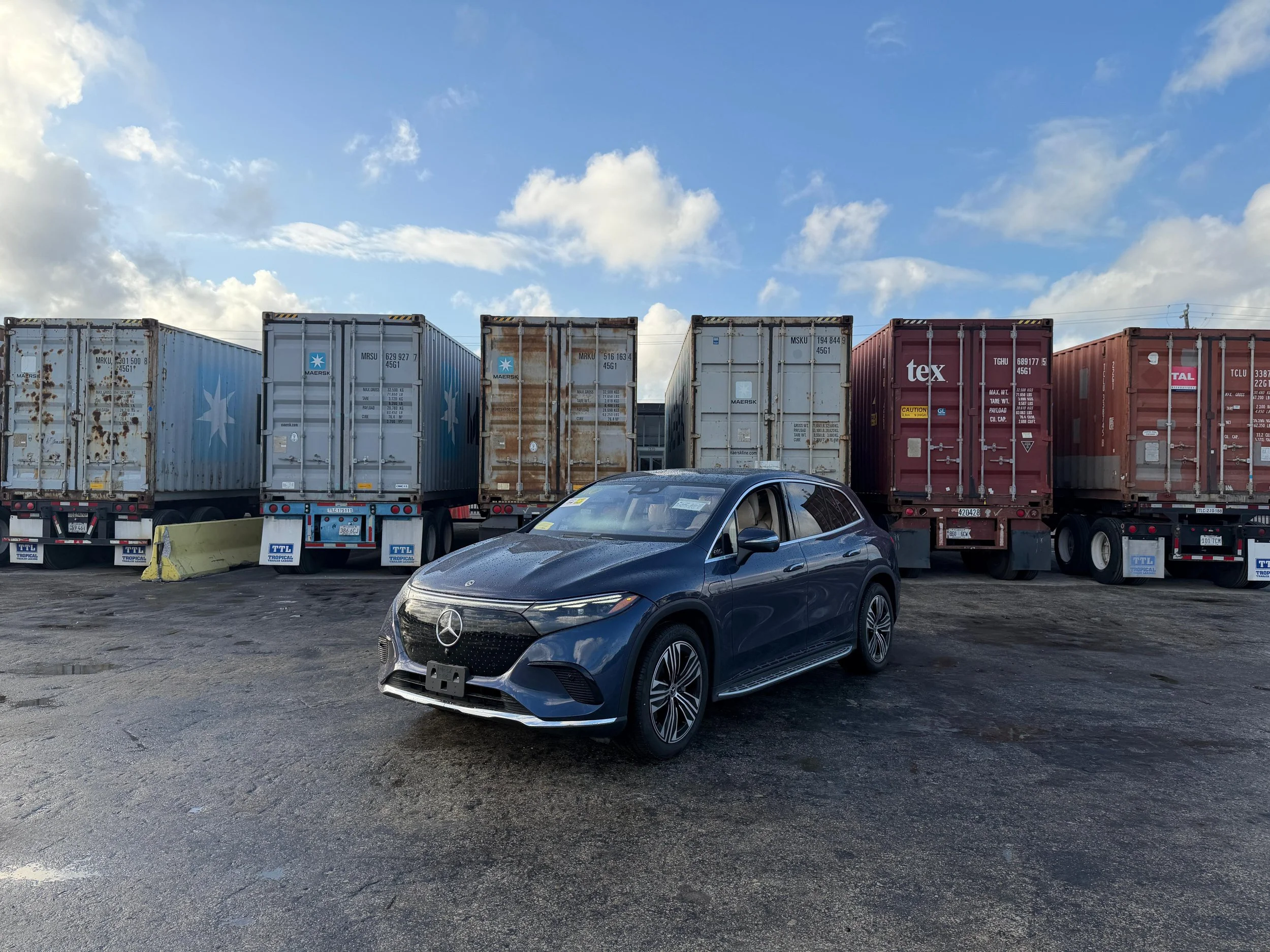 International car shipping from Miami port with container vessel and cargo operations. Global freight shipping services for vehicles, containers, and cargo from USA. Car shipping service loading vehicle into container for international transport.