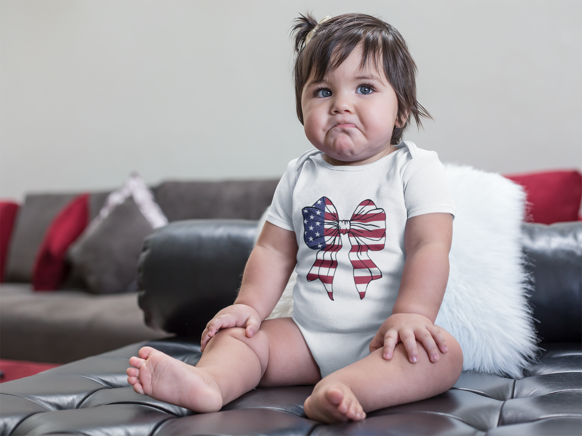 mockup-of-a-sad-baby-girl-wearing-a-onesie-sitting-on-a-leather-couch-a14049.png