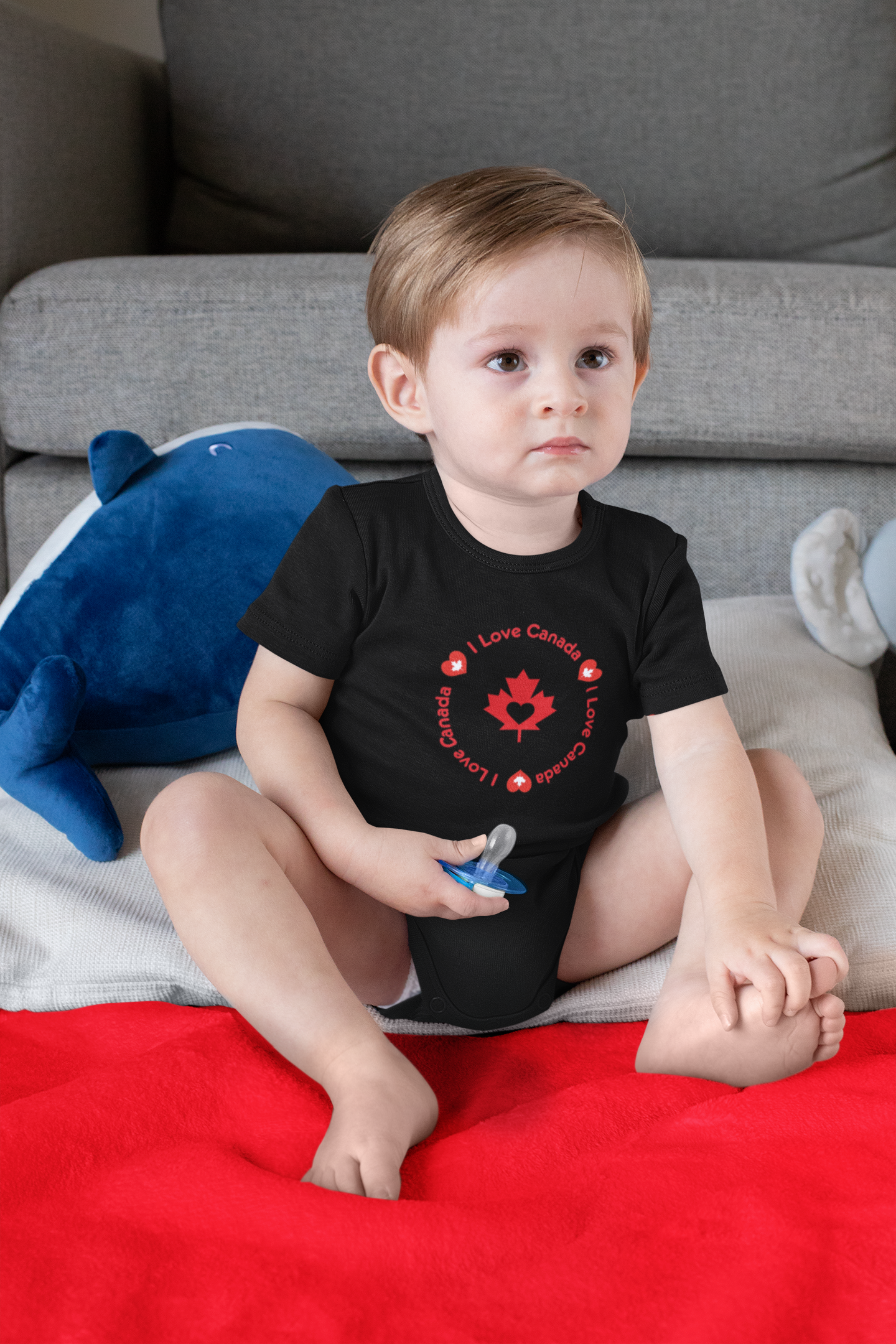 onesie-mockup-of-a-boy-sitting-on-a-sublimated-blanket-30015.png