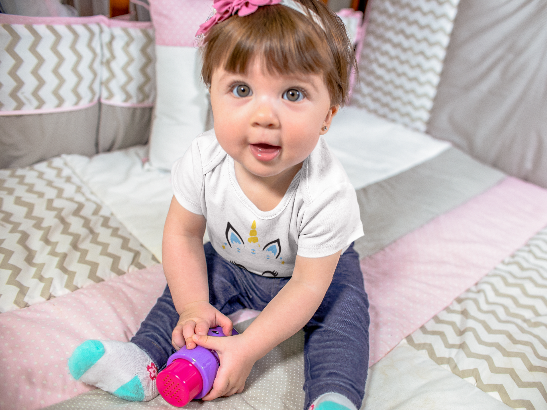 beautiful-baby-girl-sitting-down-happy-while-wearing-a-onesie-and-playing-with-her-purple-and-pink-toy-mockup-a13956 (1).png