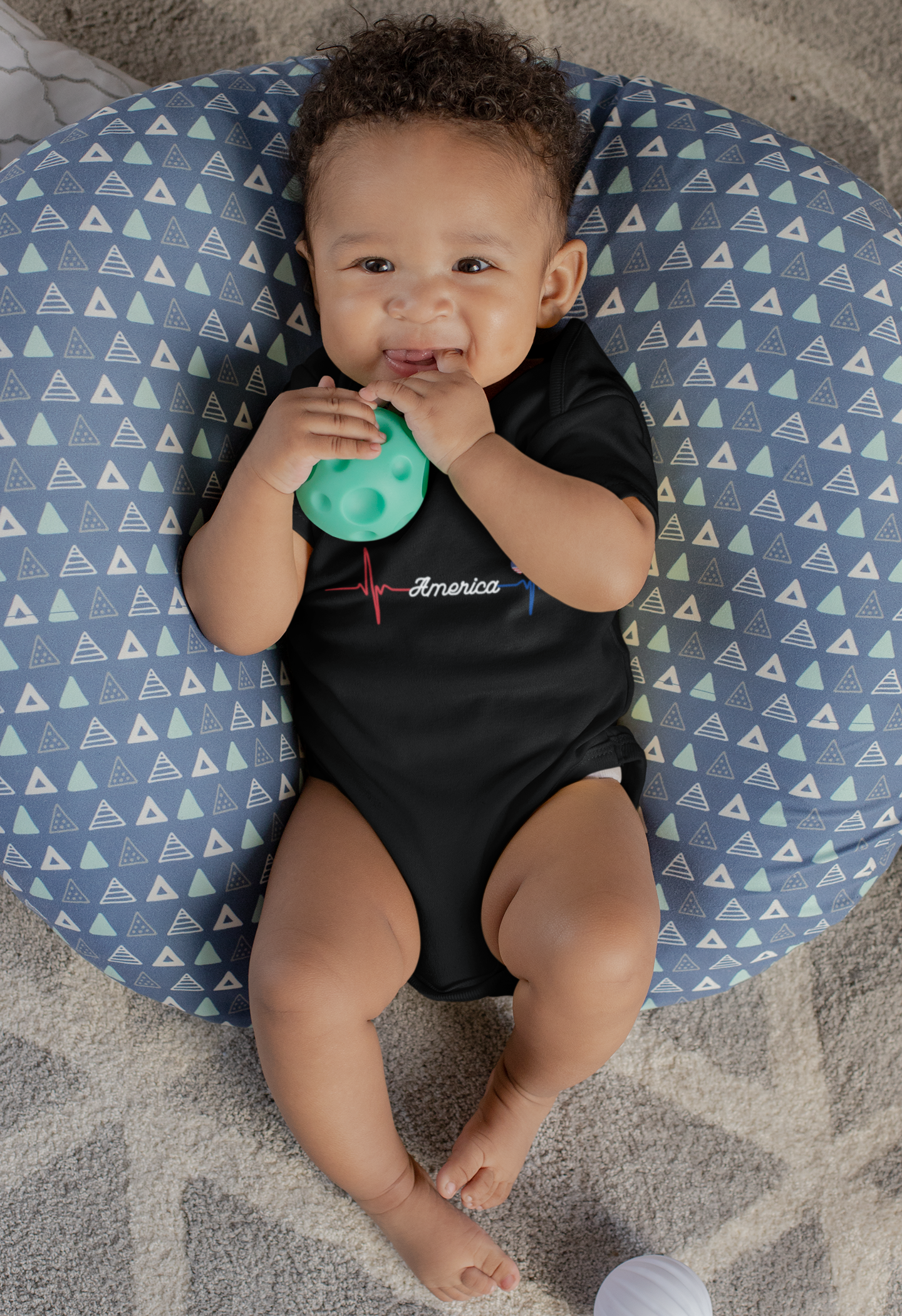 mockup-of-a-sweet-baby-boy-with-a-onesie-lying-on-a-big-pillow-25119 (1).png