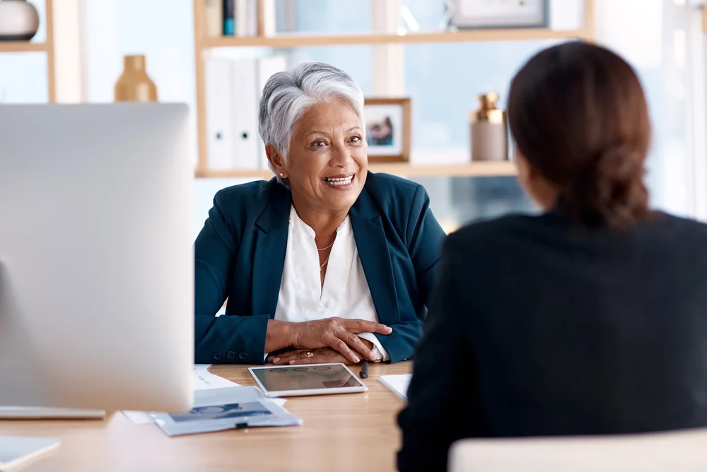 Two colleagues building connection through a supportive workplace conversation