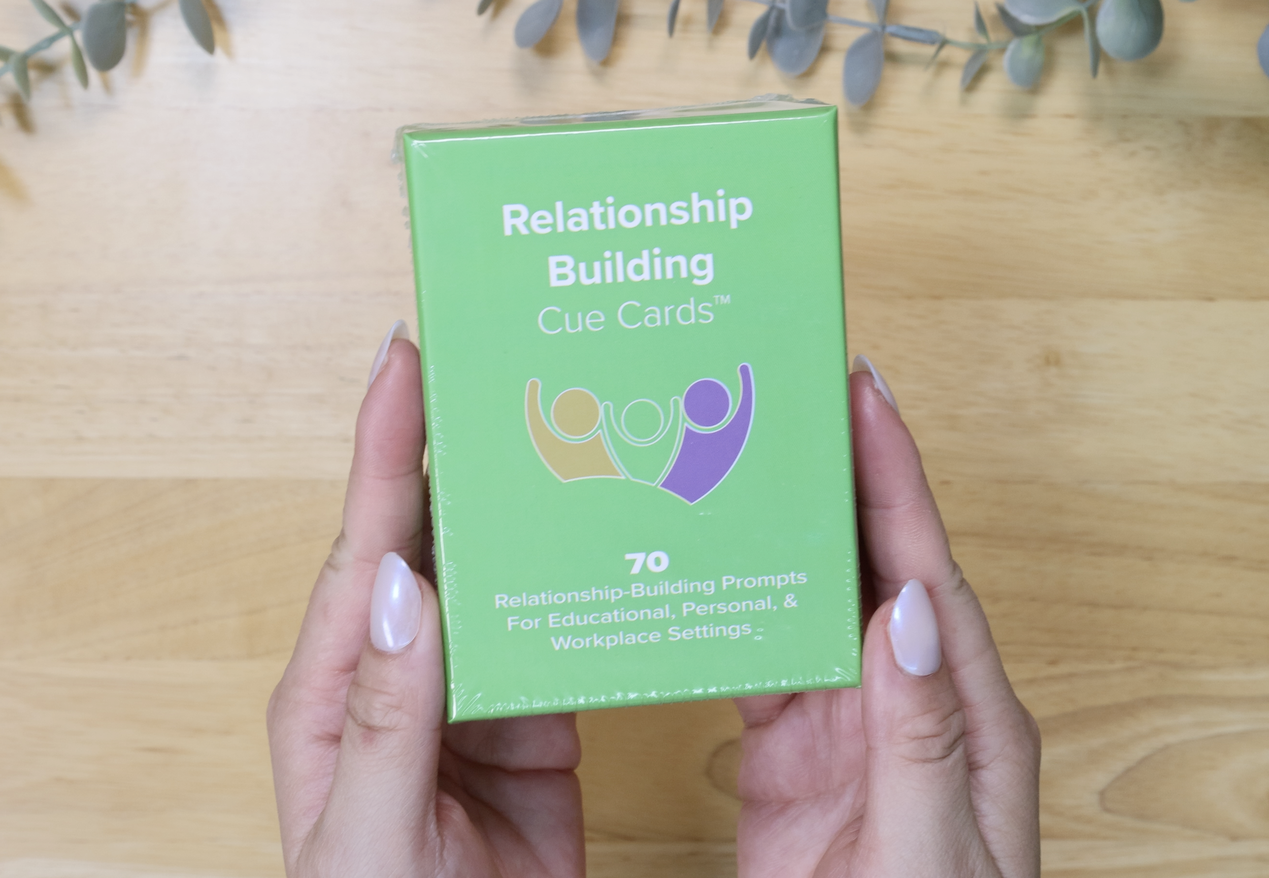 Woman holding team building card box
