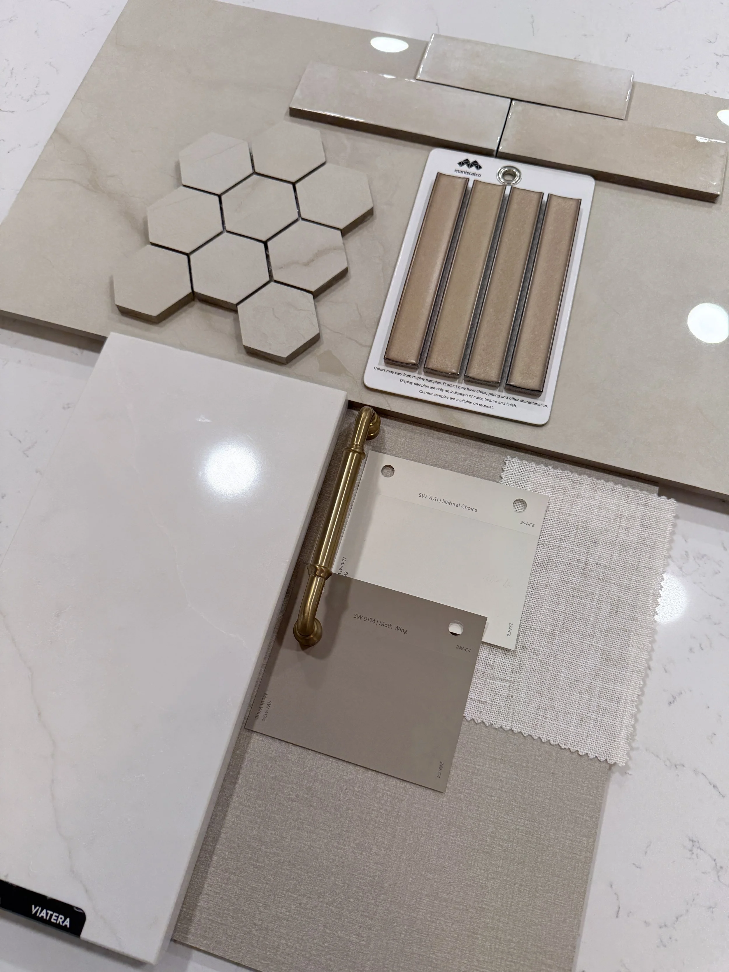 Interior finish palette with cabinetry, tile, quartz, paint, fabric, and brass hardware selected by Studio MWR.
