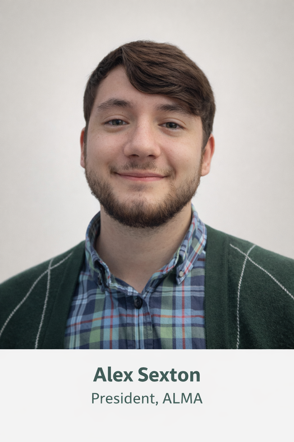 Headshot of a young man with brown hair and a beard, smiling, wearing a green cardigan over a plaid shirt, with text below that reads "Alex Sexton, President, ALMA."