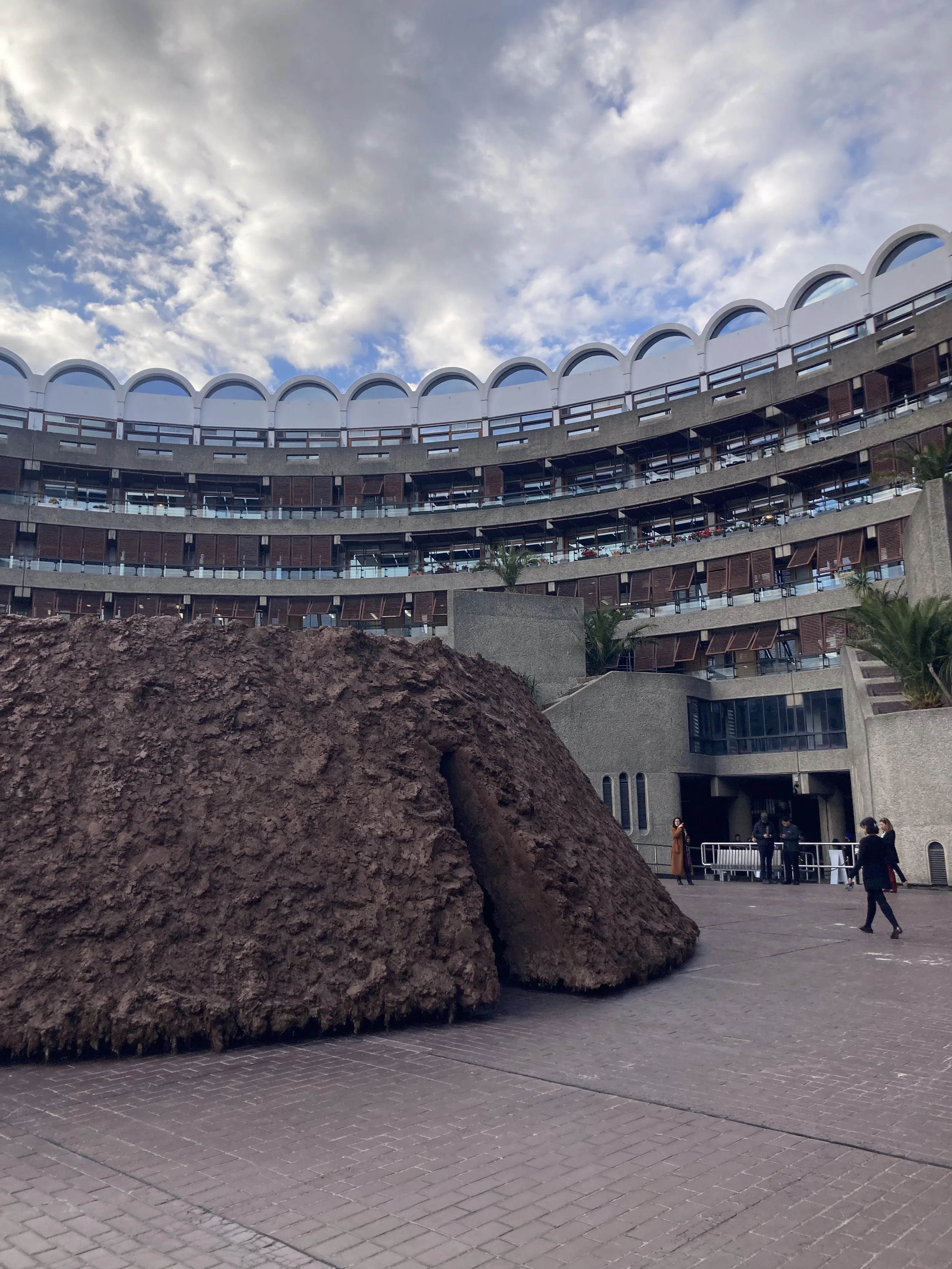 Delcy Morelos, origo, 2026, clay, soil, hay and plant seed, site-specific installation at the Barbican, London. Photo by Kelly Jin Mei.