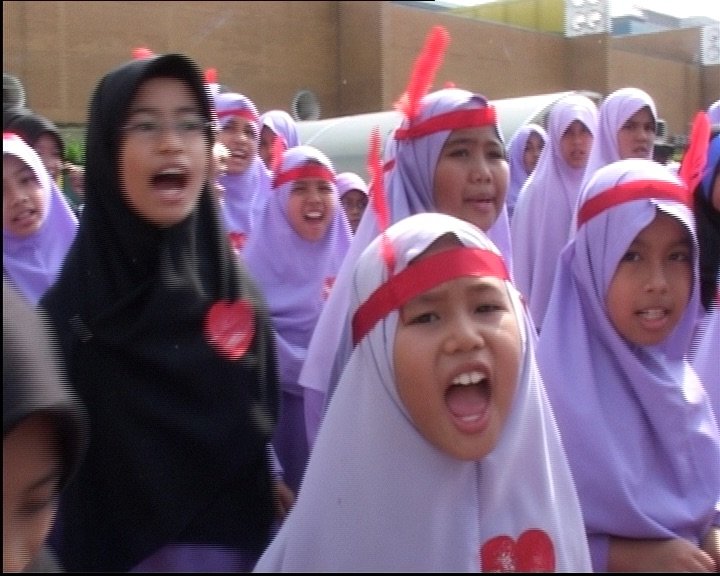 Still from Singapore GaGa (2005). Madrasah students chanting cheers during their sports day