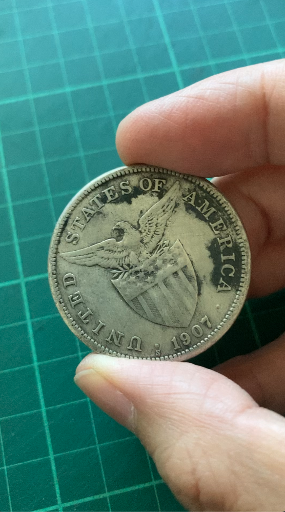 Still from a video documentation of the coin being filed and ground to dust. Image courtesy of the artist.