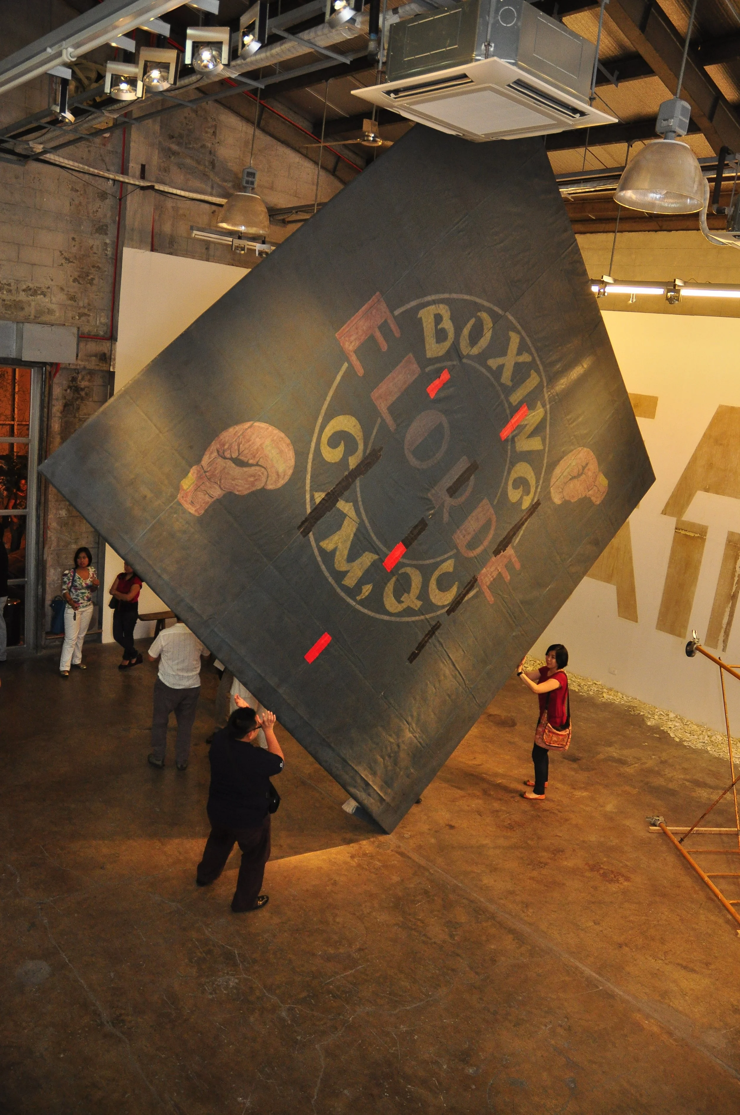Nilo Ilarde, The Triumph of Painting, 2010, used boxing canvas from Elorde Boxing Gym, dimensions variable. Exhibition view in Finale Art File, Makati City, Philippines. Photo by MM Yu.