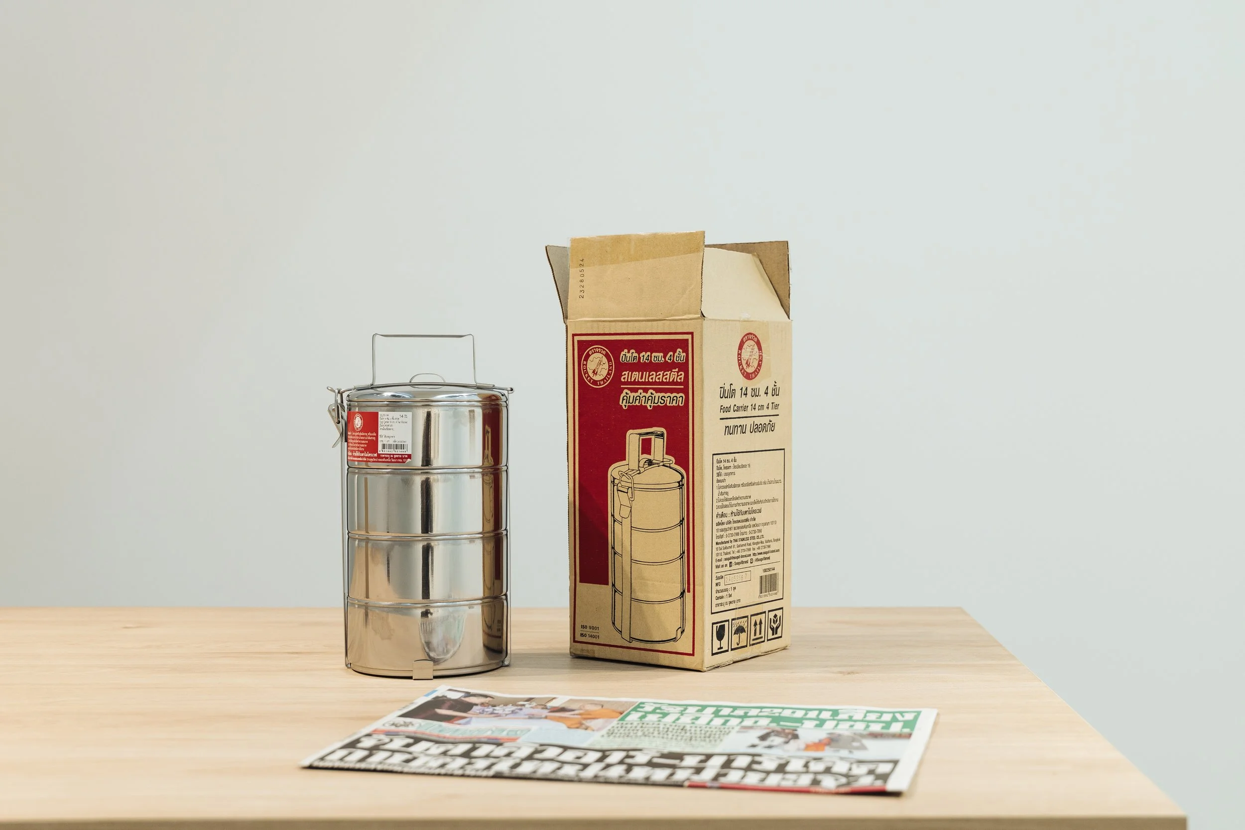 Rirkrit Tiravanija, untitled (lunch box), 1996, stainless steel container, Thai newspaper and Thai meal, 31.5 x 16 x 18 cm. © Rirkrit Tiravanija / STPI. Image courtesy of STPI, Singapore.