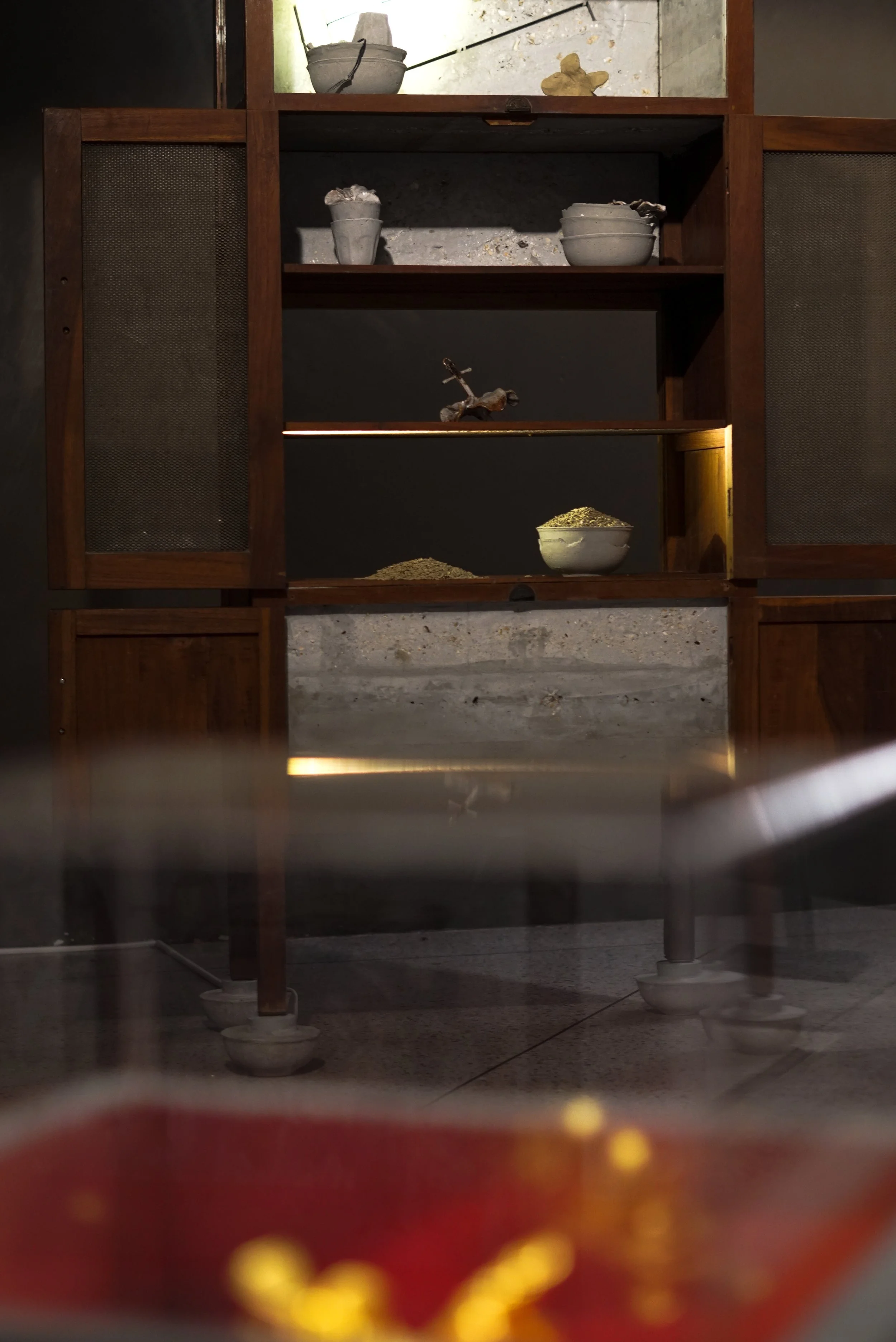 Prach Pimarnman, Pantry from Homeland 2, 2024, cement, steel rattan anklet, rice grains, glass cup, and gold ceramic flowers, 170 x 76 x 60 cm. Image courtesy of Prach Pimarnman.