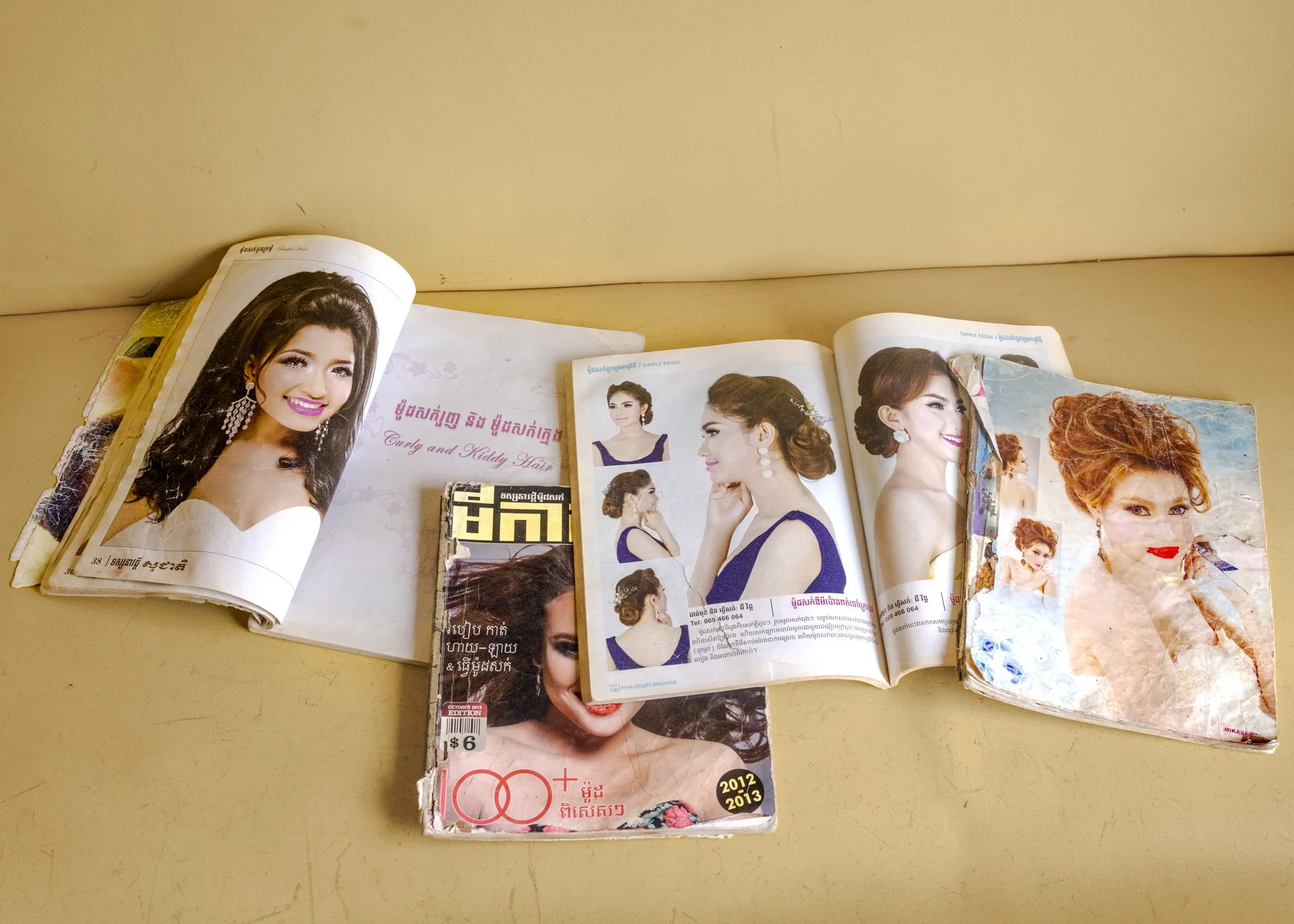 “Once upon a time, magazines like these that featured stars with overcoiffed hairs, piled over counters in hair salons. Some still have them, but most no longer do. A salon owner was kind enough to donate a pile to me.” Image courtesy of the artist.