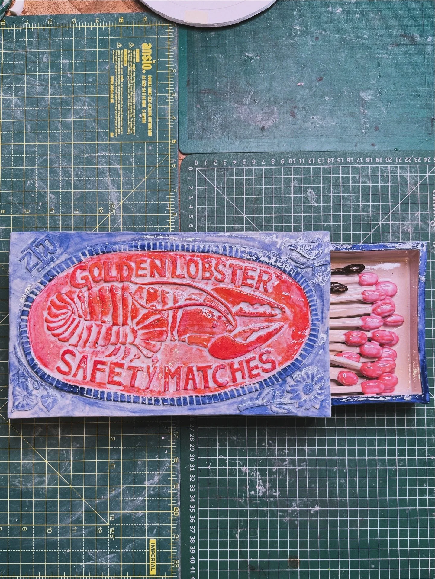 GOLDEN LOBSTER

This formidable matchbox measures about 35cm in length. Complete with &lsquo;burned&rsquo; matches, as you&rsquo;d find in any real matchbox, this ceramic beast is going to find a home in my own home. Adorned with my wife&rsquo;s init