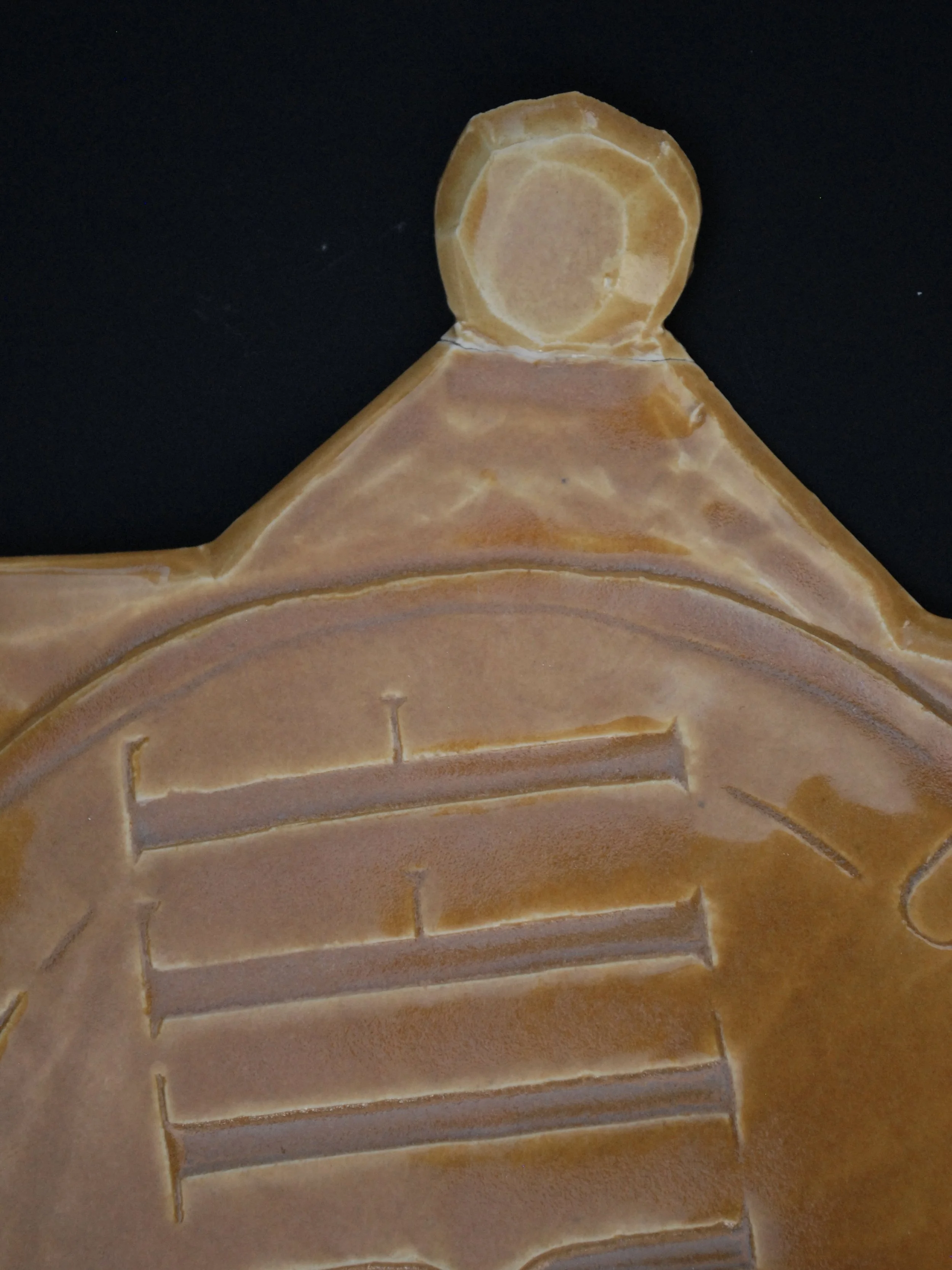 Image is of a ceramic sheriff's badge inspired by the Wild West, it features the inscription ‘Fort Hope, New Mexico Sheriff’ in raised lettering and is coloured all over in a warm yellow earthy glaze.