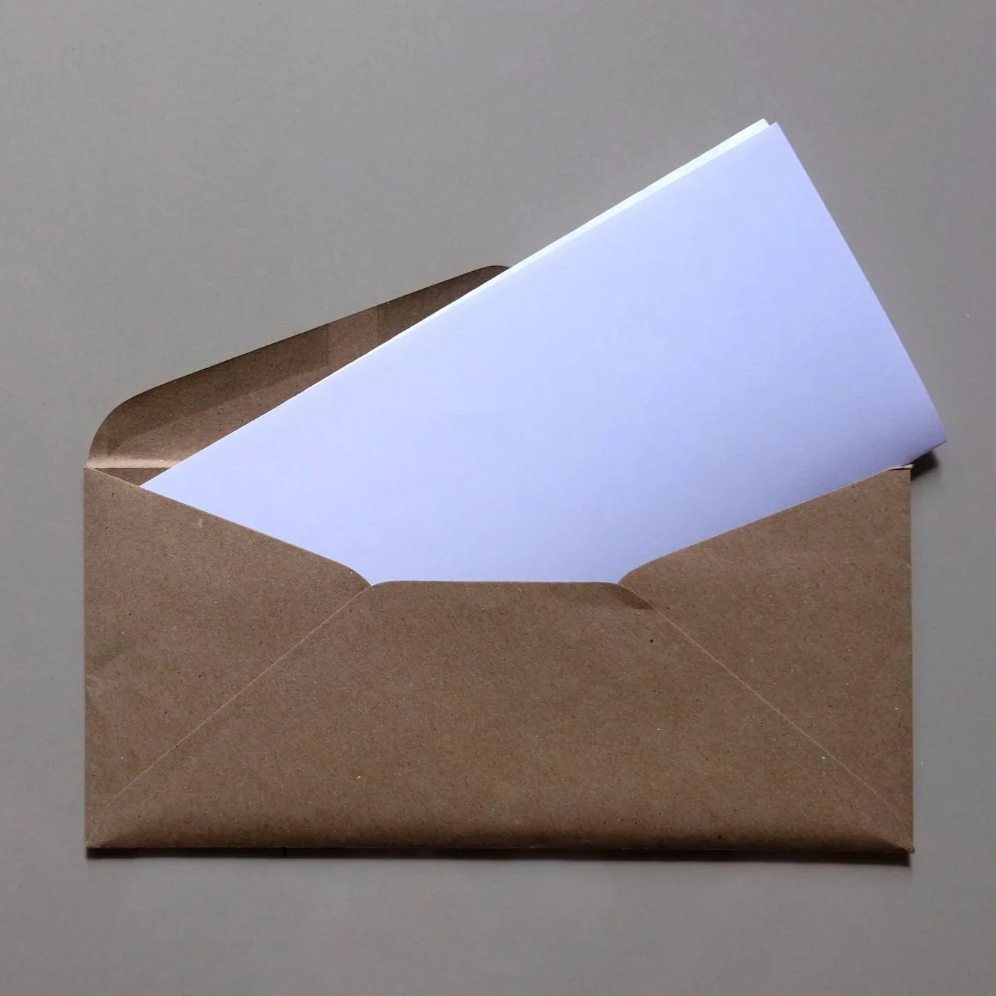 brown-envelope-front-with-card-inside-on-white-bac-2024-12-06-08-16-55-utc.jpg