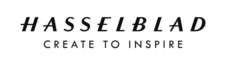 hasselblad-logo in schwarzer schrift auf weißem grund und dem claim create to inspire