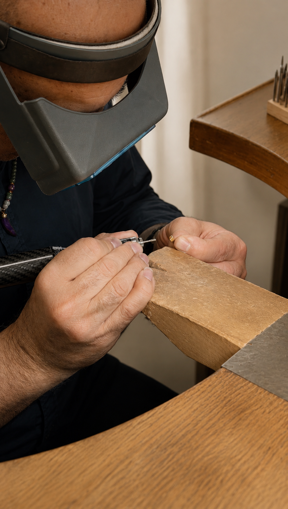 Goldsmith working on a benching on a gold piece of jewellery