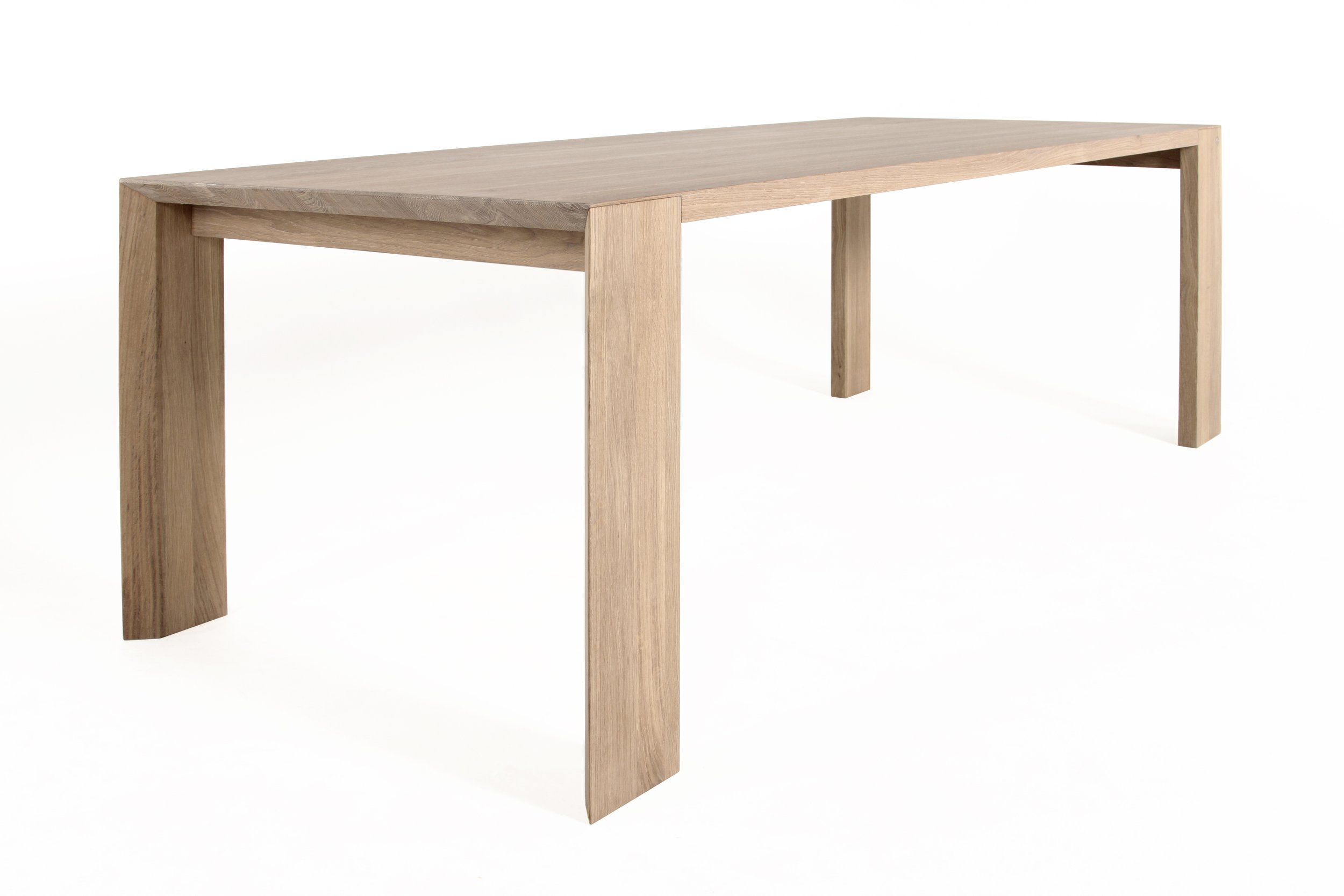 Wooden dining table with simple design on white background.