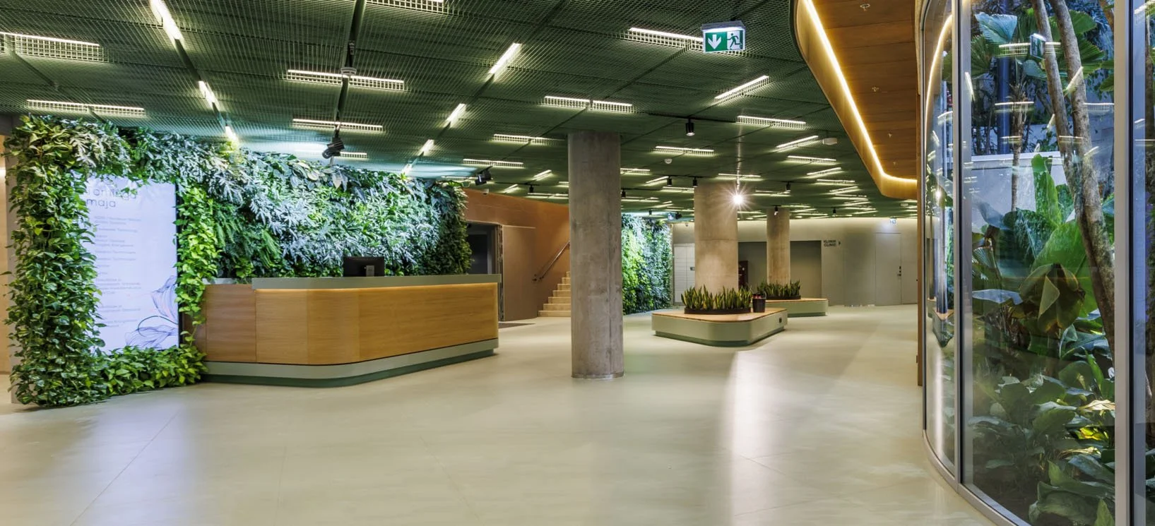 Modern indoor lobby with green walls and plants