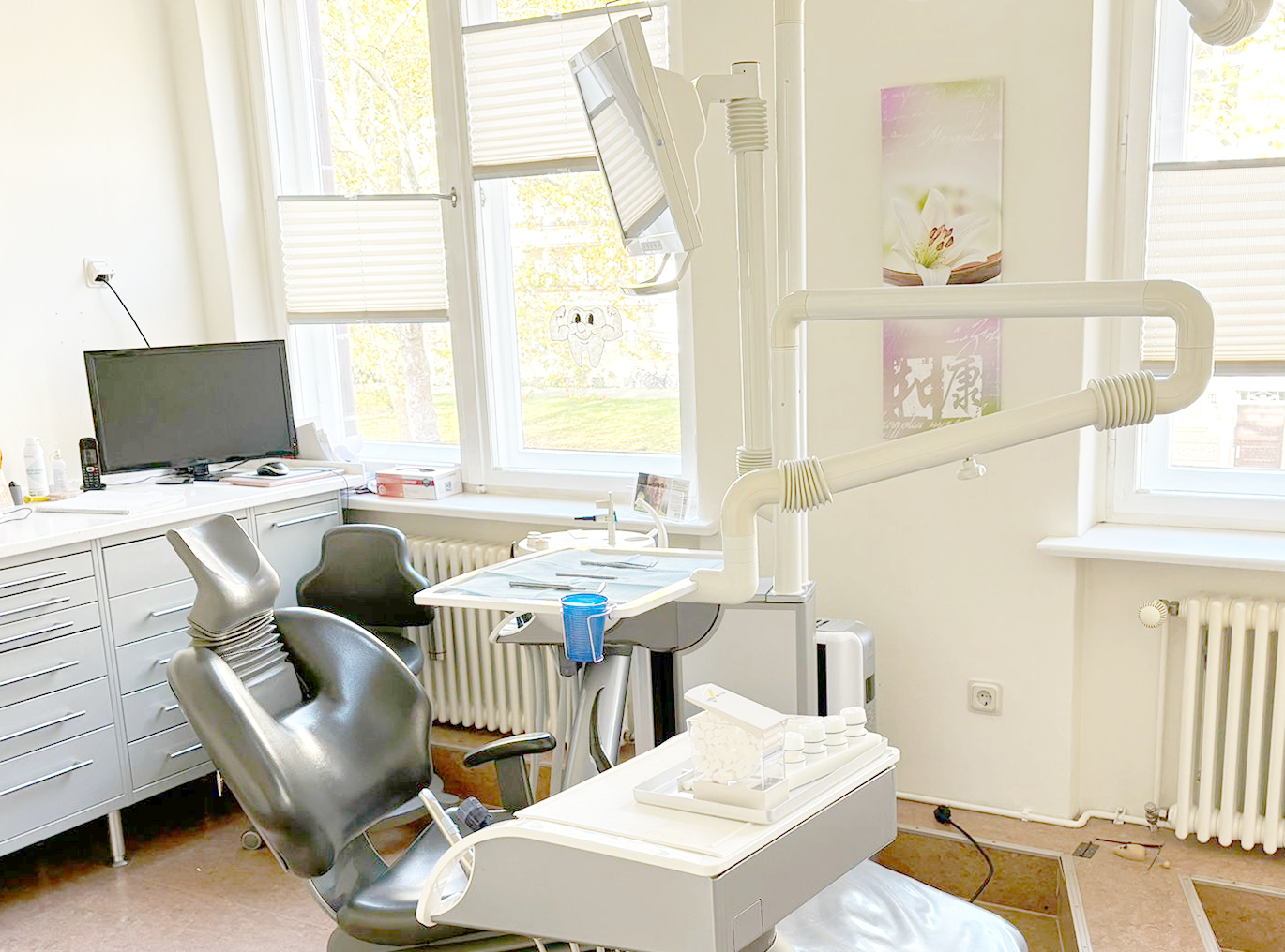 Modern dental office with a dentist chair and equipment.