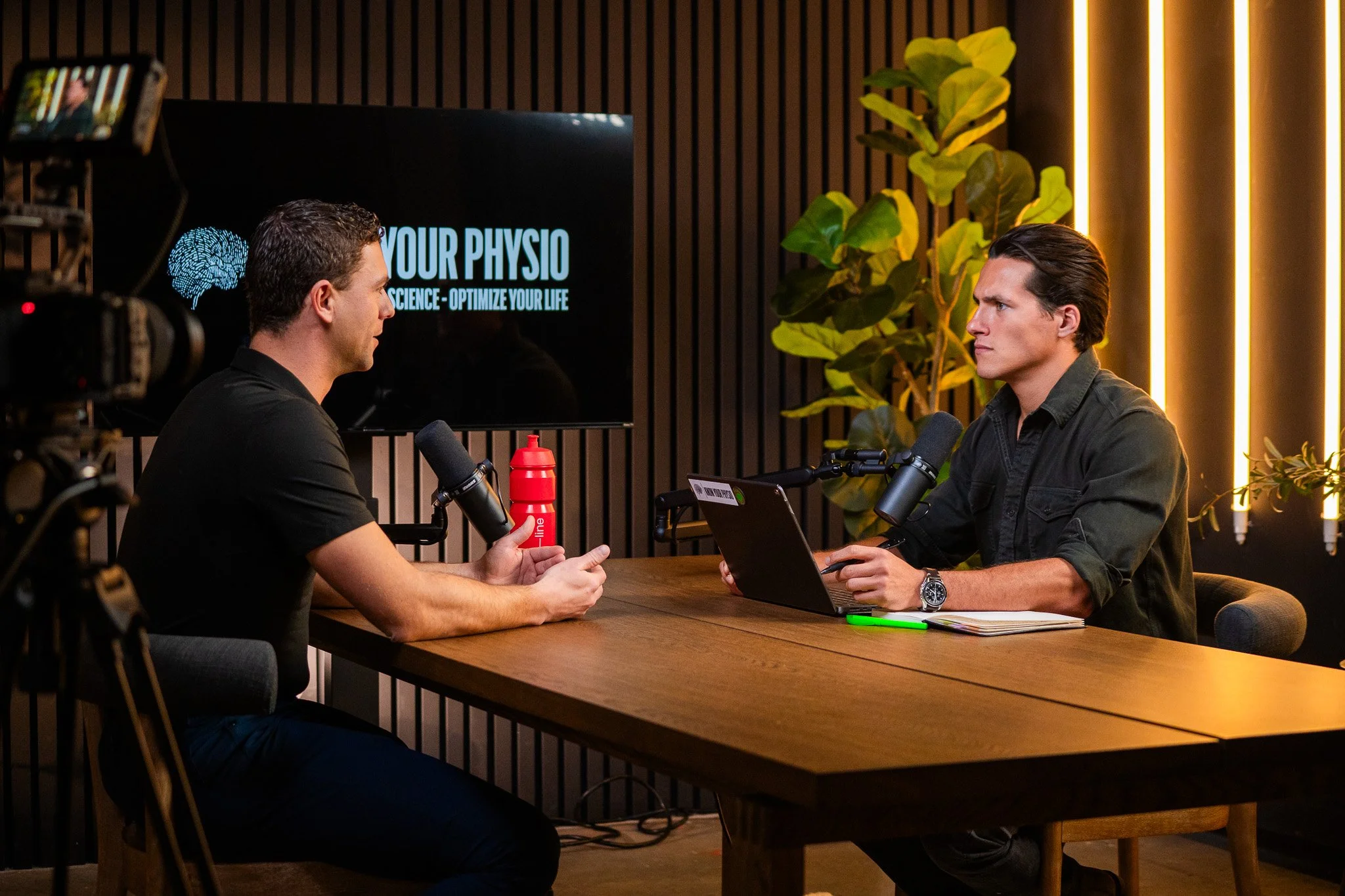 Two men filming a podcast with high quality cameras. video production services.