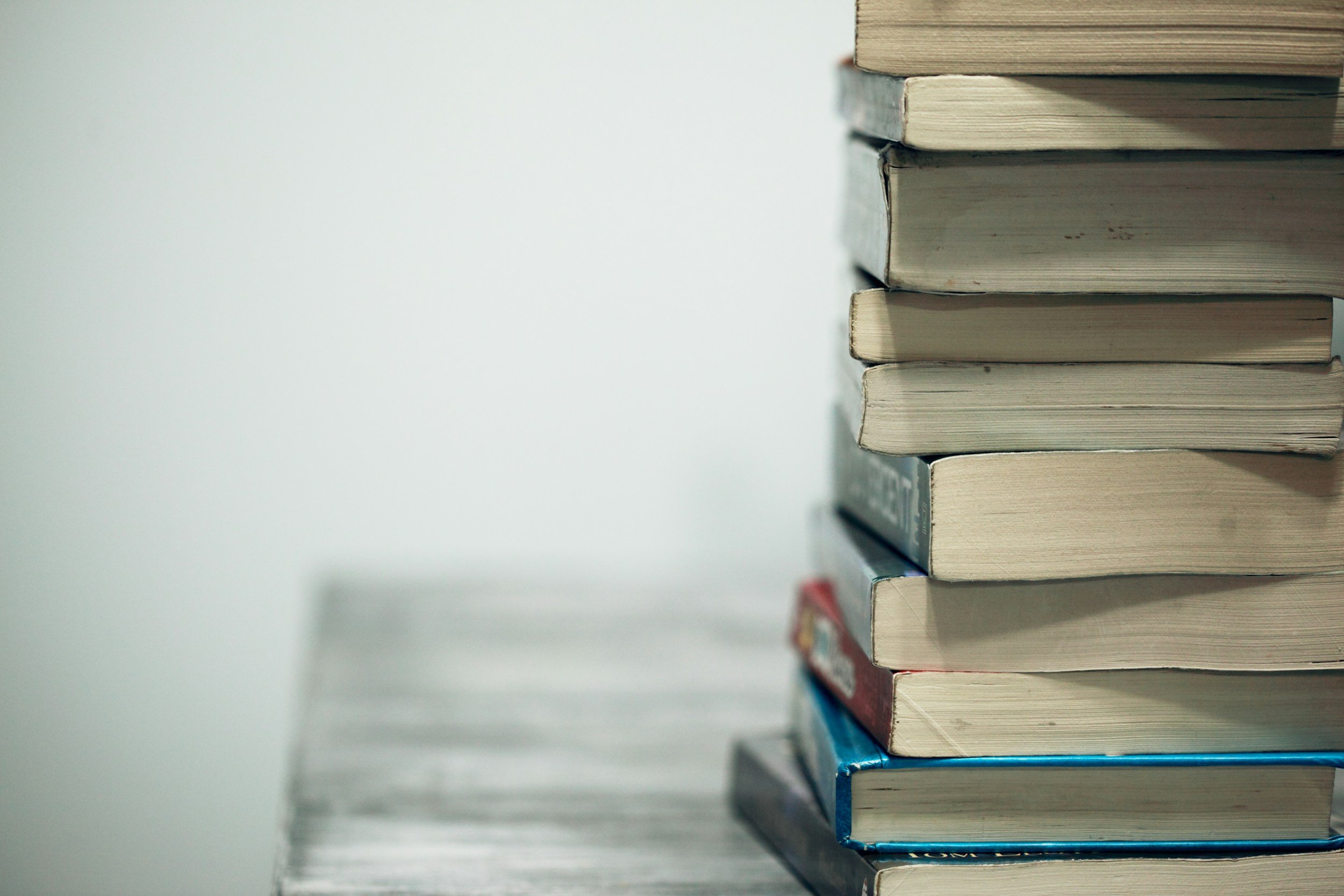 Stack of books on a wooden surface