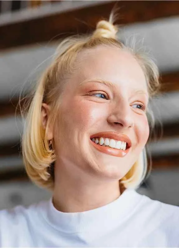 Portrait of a young woman smiling while looking away from the camera