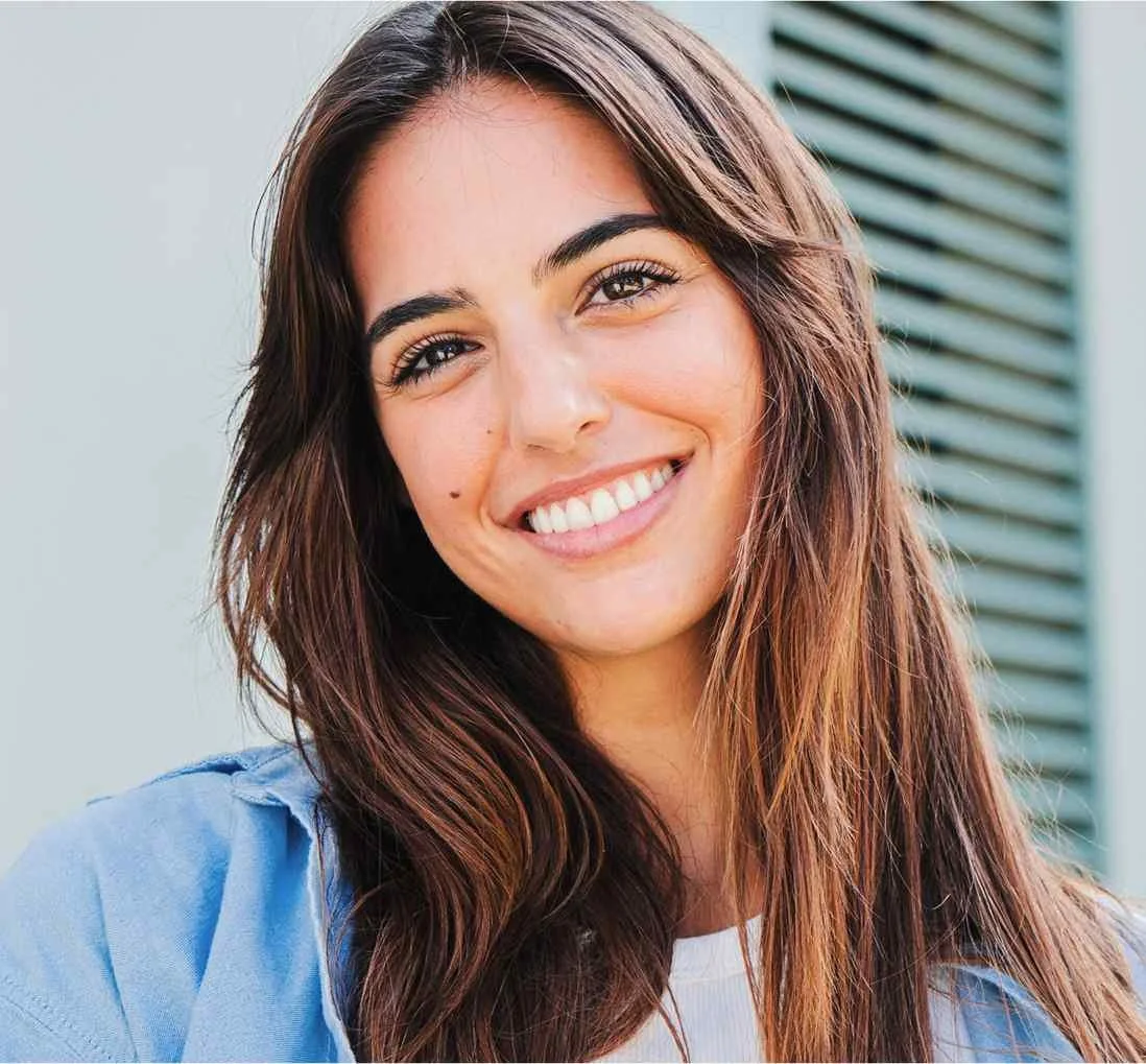 Portrait of a young woman smiling brightly at the camera