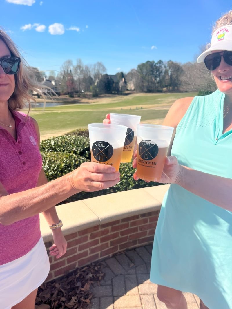 Our mobile bar setup at a fun golf-themed party in Oconee County, GA featuring guests enjoying beverages poured from Athens on Tap's mobile beer & cocktail trailer built-in custom drink taps.