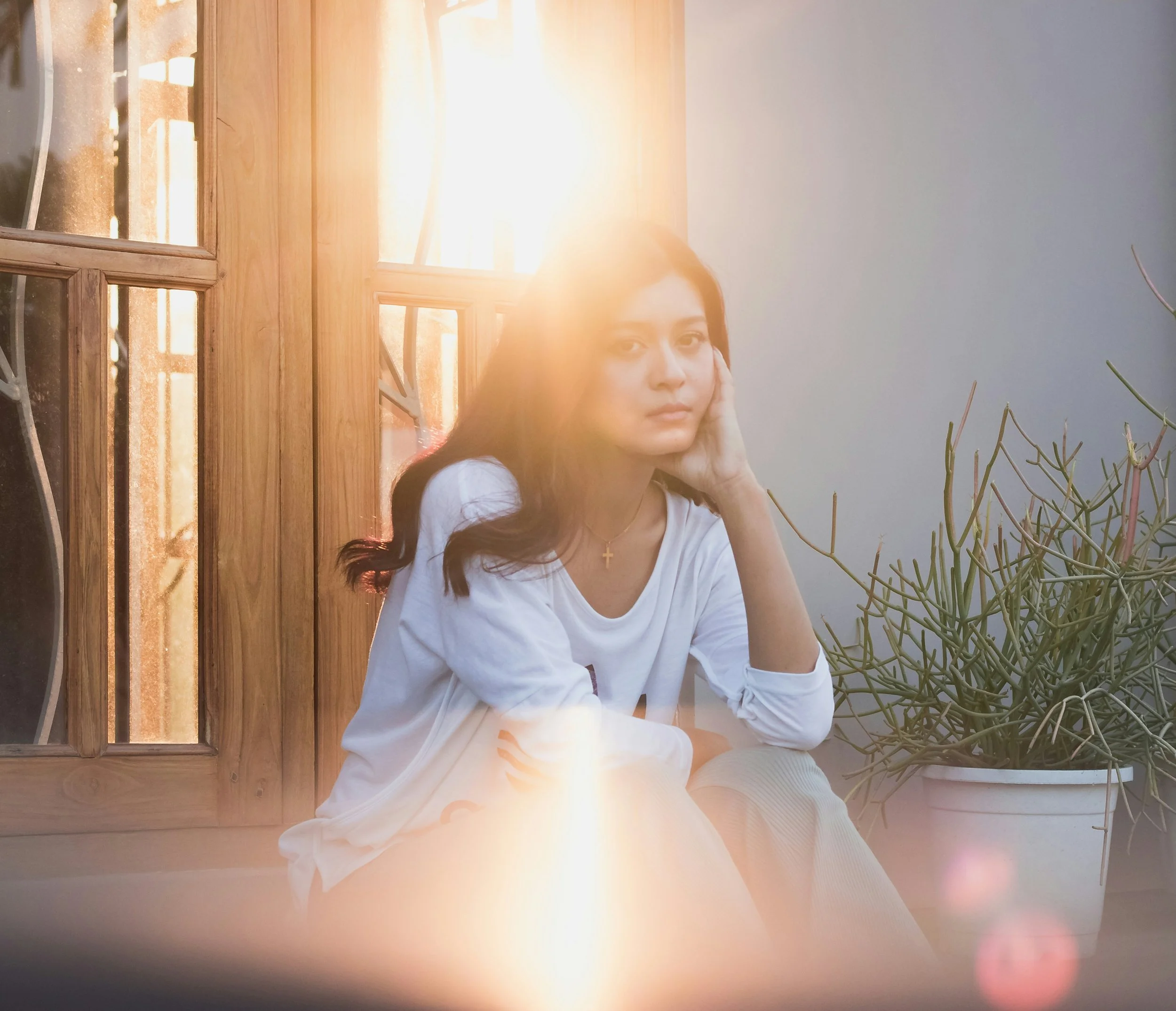 Woman looking at camera looking pensive.