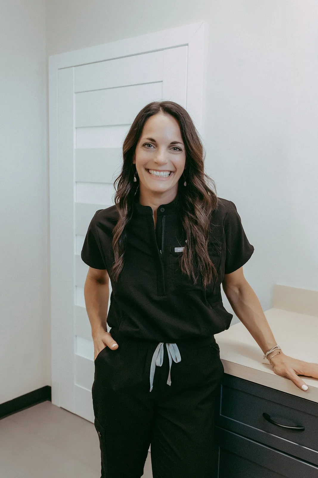 A woman smiling standing in a room.