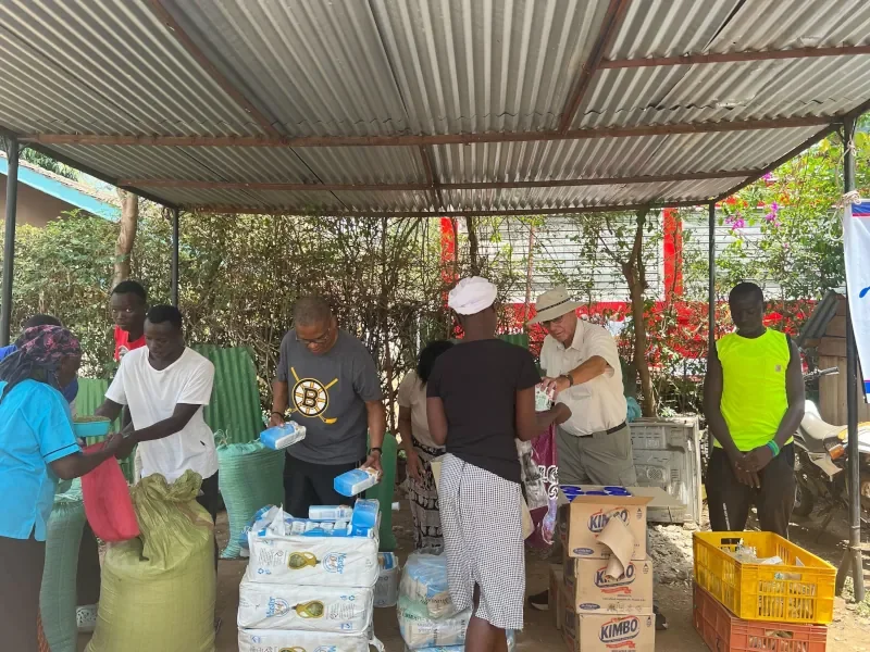 Mission team members distributing food for Life For Children Ministry to orphans and families in western Kenya