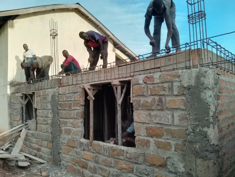 Construction workers building an addition to a school on ministry land in Kenya