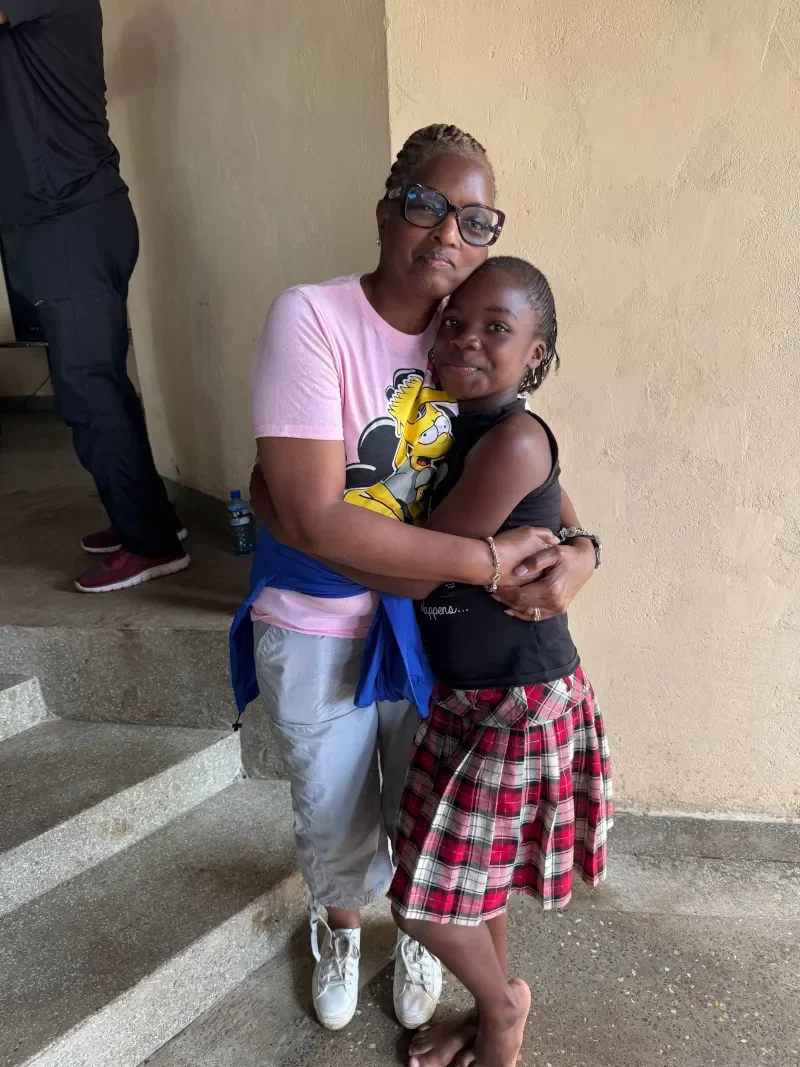 Mission volunteer embracing a Kenyan child during a Life For Children Ministry outreach visit