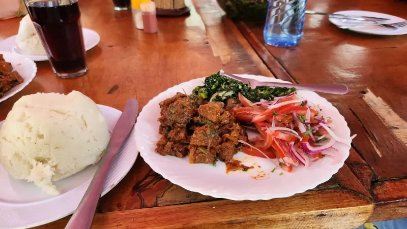 Traditional Kenyan ugali meal shared by mission volunteers and local community members