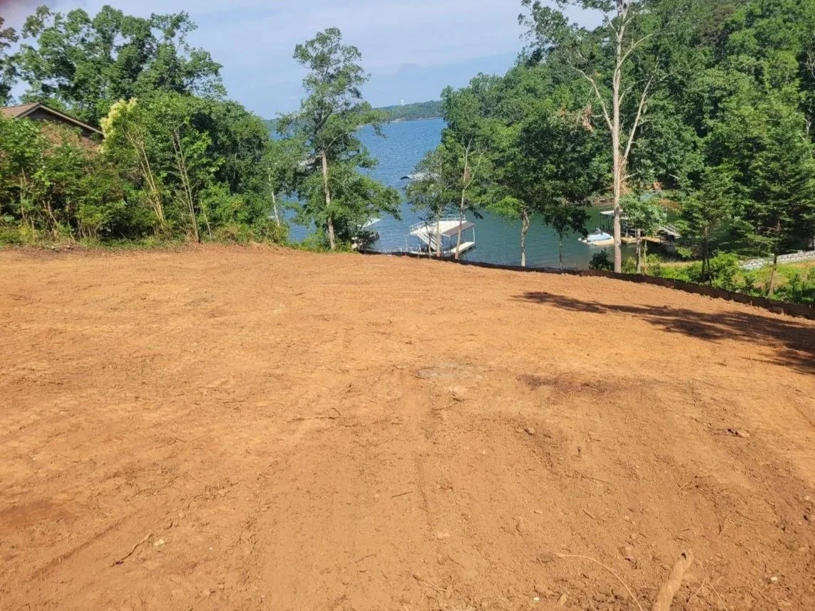 A upscale residential site work project with cleared trees, graded lot, and ready for the next step: Professional Tree Guys